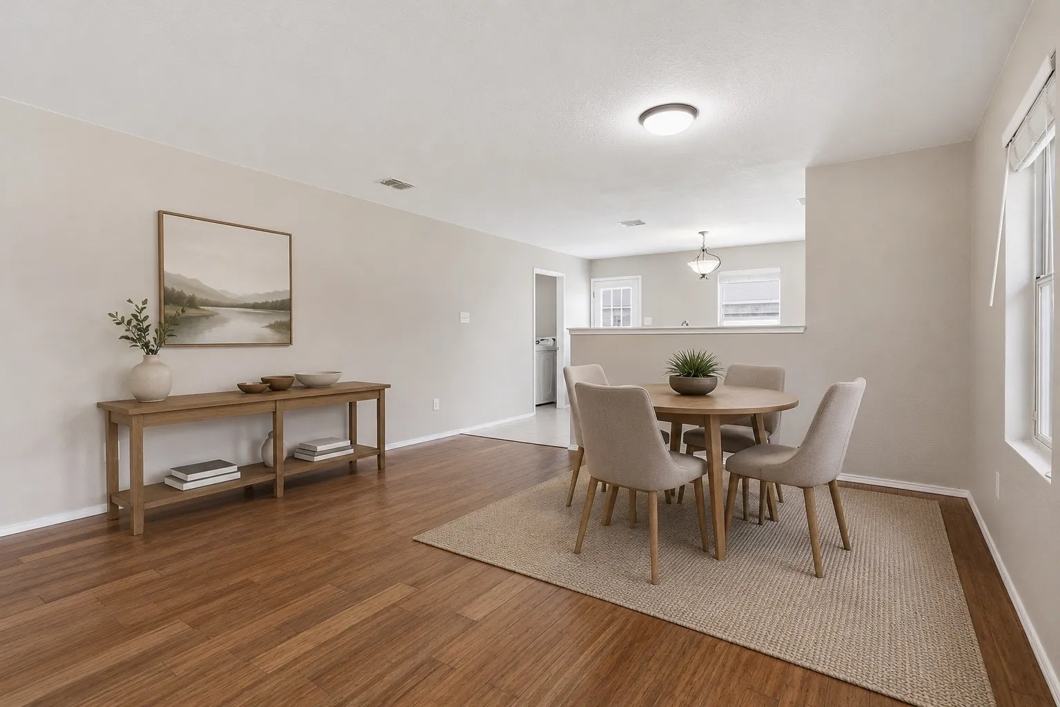 Open-concept living space with wood-finish flooring *Virtually s
