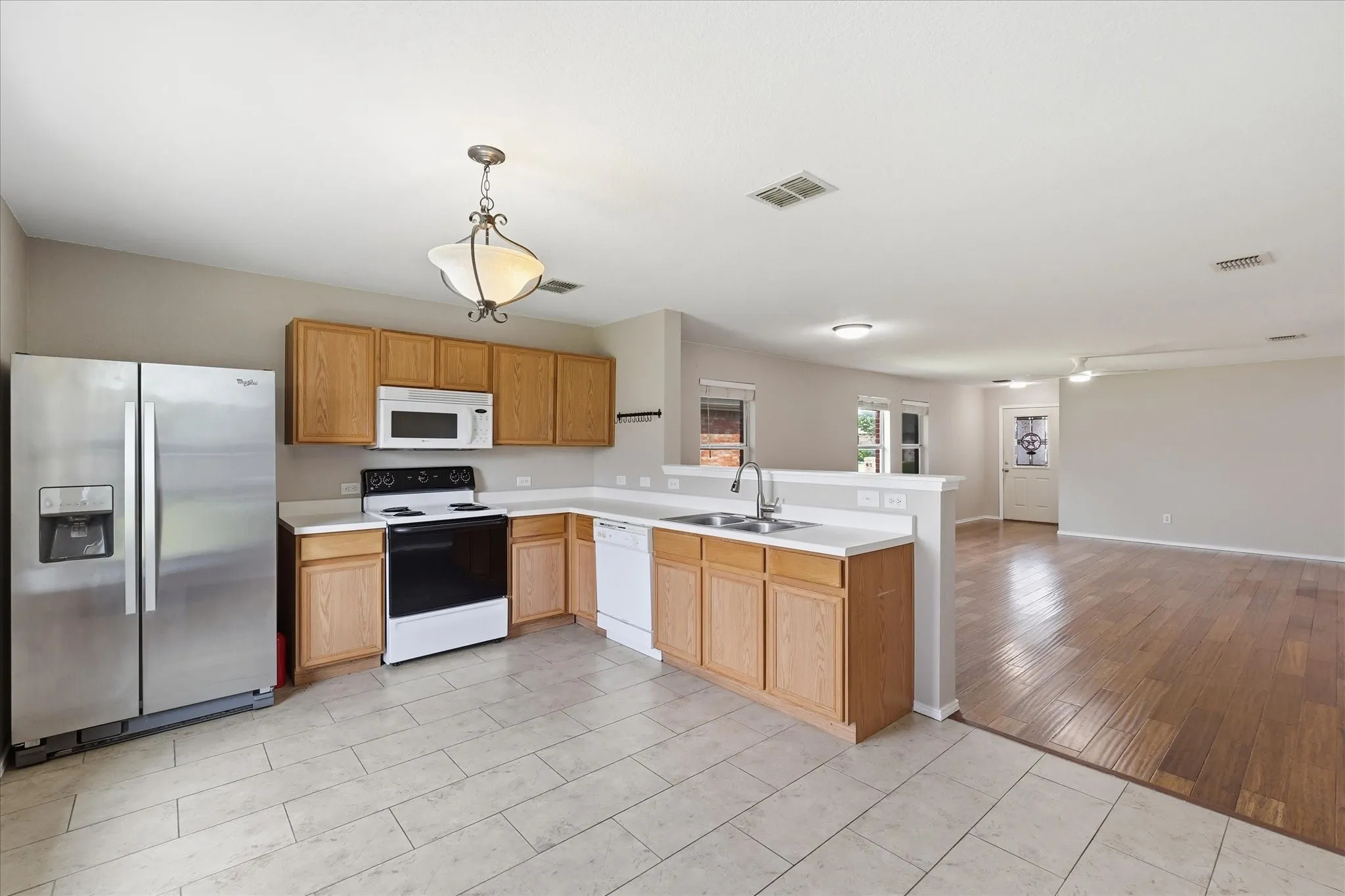 Kitchen featuring wood cabinetry, solid surface countertops, and stainless steel appliances