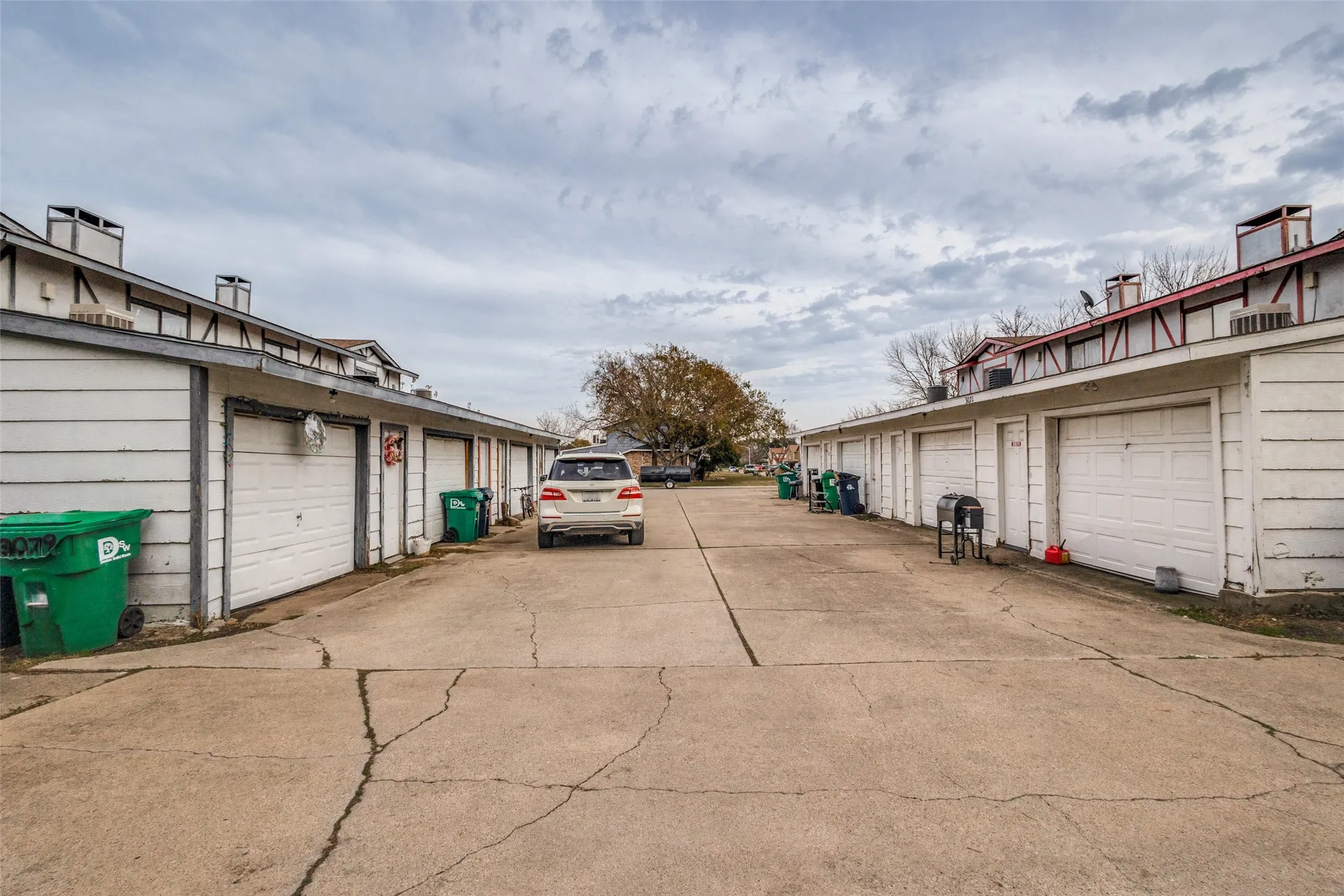 Notice each unit in the quadruplex has its own 1-car garage.
