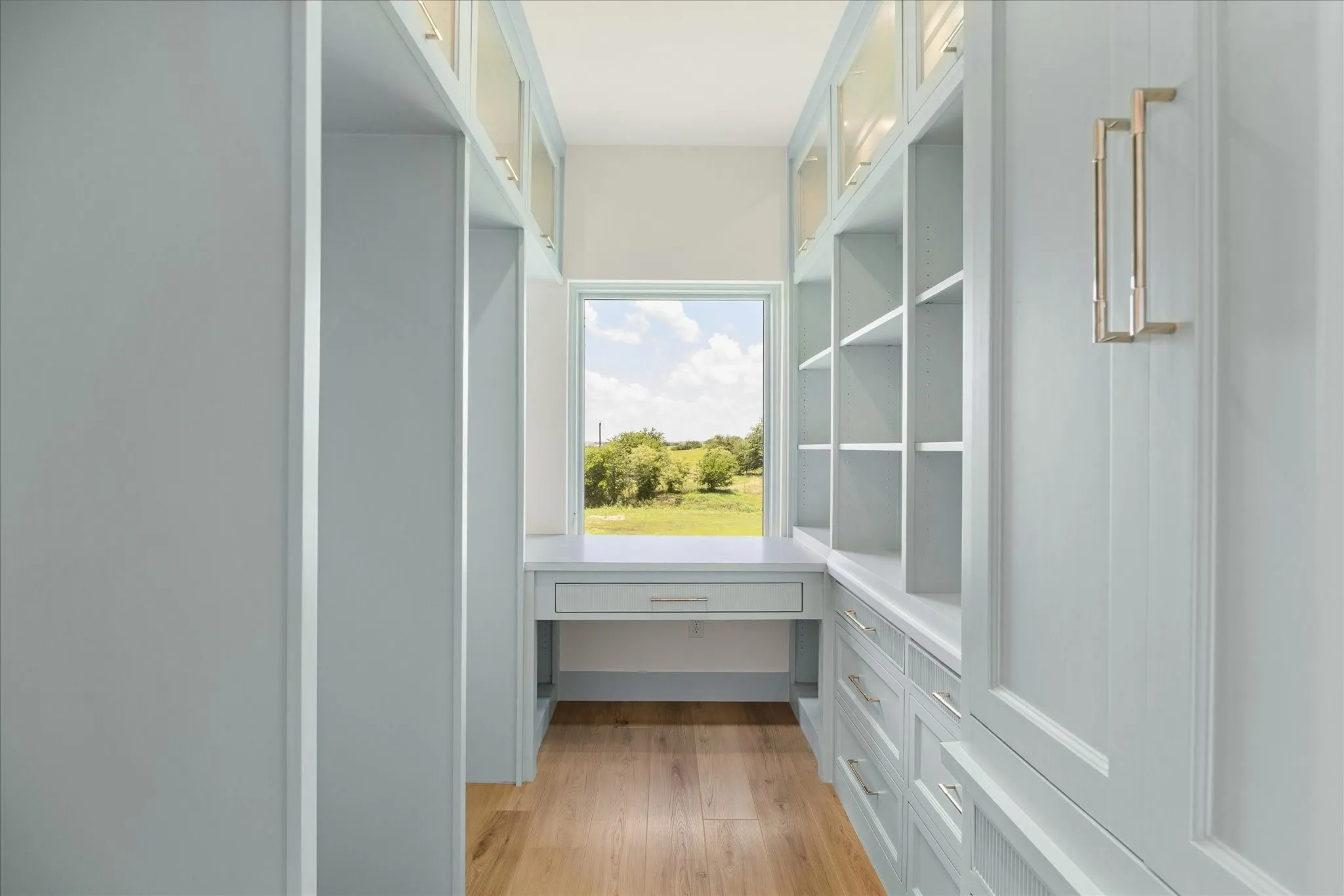 One of The Two Upstairs Custom Closets with Vanity, Custom Cabinetry, Storage, and Open Shelving