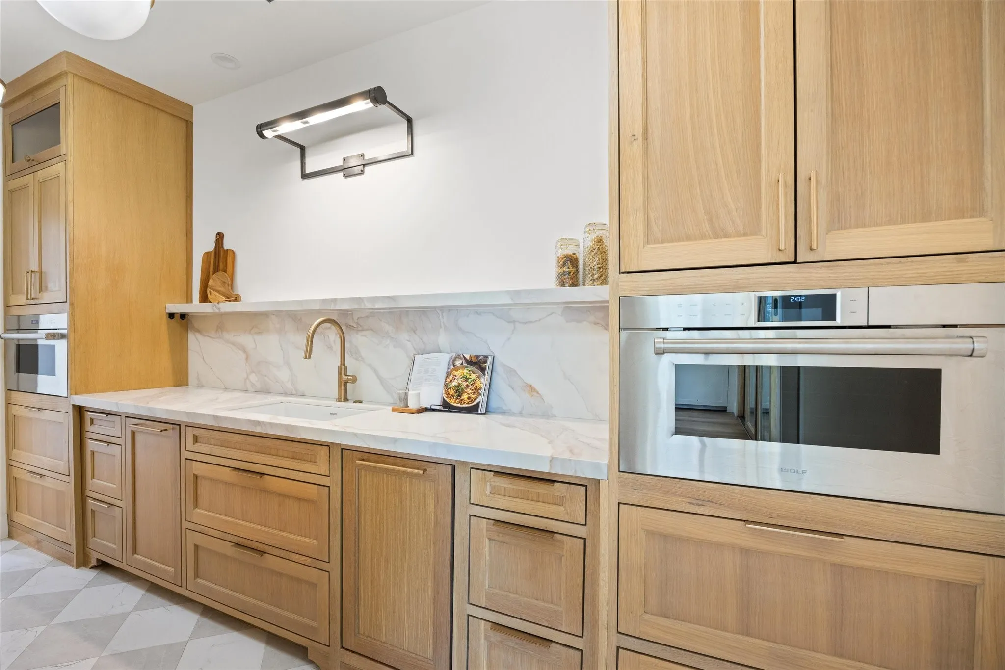 Custom White Oak Butler's Pantry with Quartz Countertops, Wolf Steam Oven, Wolf Microwave, and a Second Paneled Dishwasher