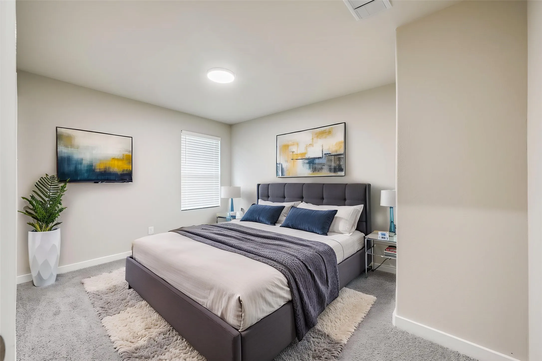 Carpeted room featuring a window with blinds, recessed lighting, and light-toned walls