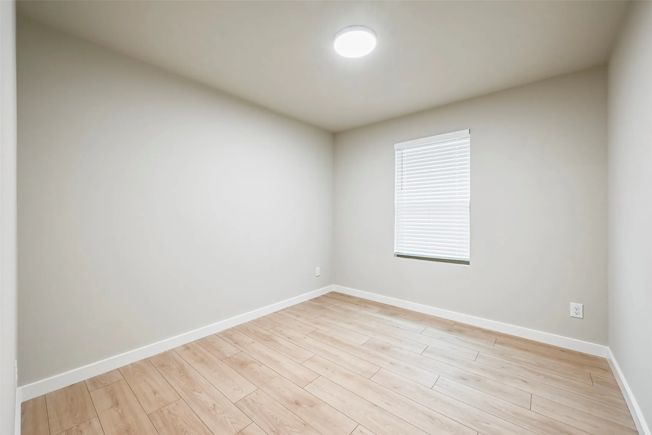 Room featuring light wood-finish flooring and neutral wall tones