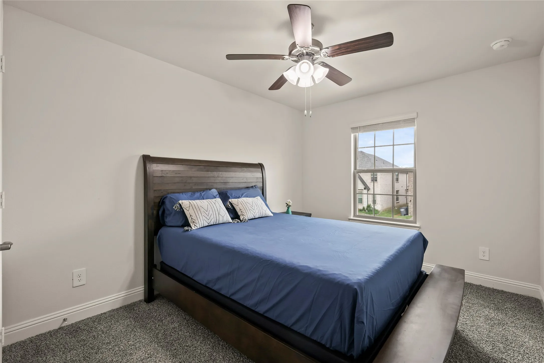 Room with neutral wall paint and plush carpeting