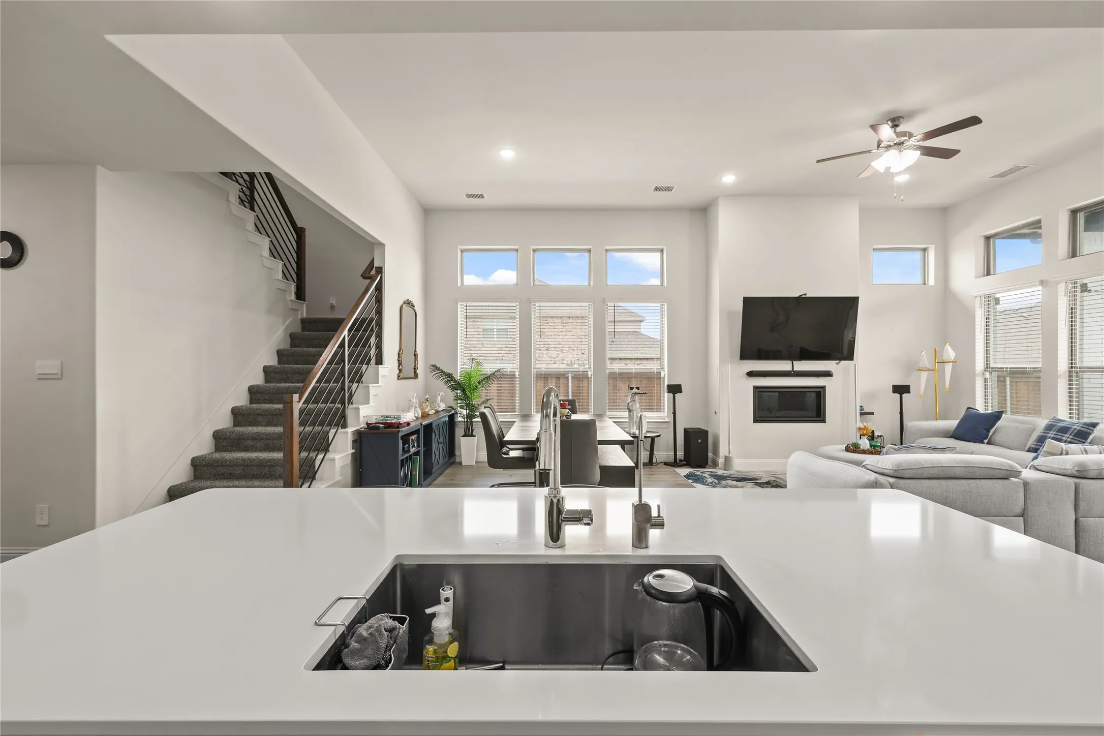 Kitchen island with an undermount stainless steel sink and a contemporary faucet