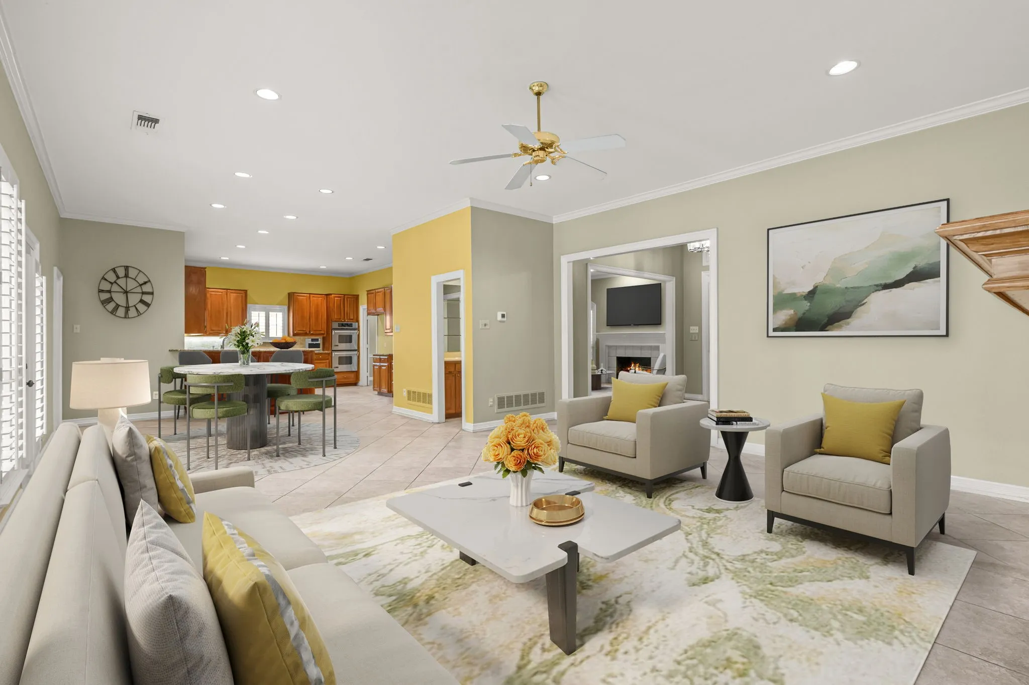 Spacious open-concept living area featuring recessed lighting, a ceiling fan, and large windows with plantation shutters