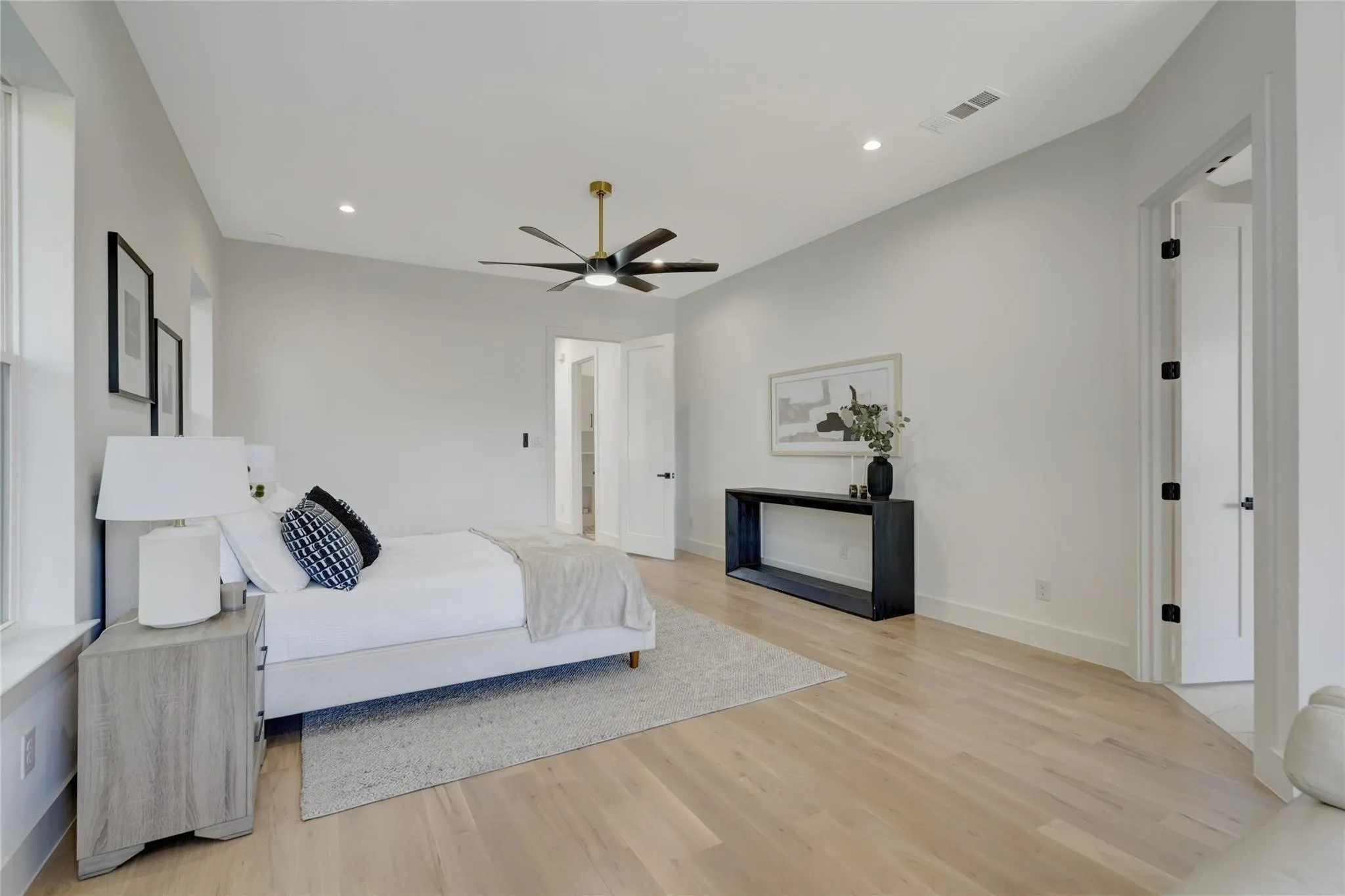 Spacious room featuring wood-finish flooring, recessed lighting, and a contemporary ceiling fan with integrated lighting