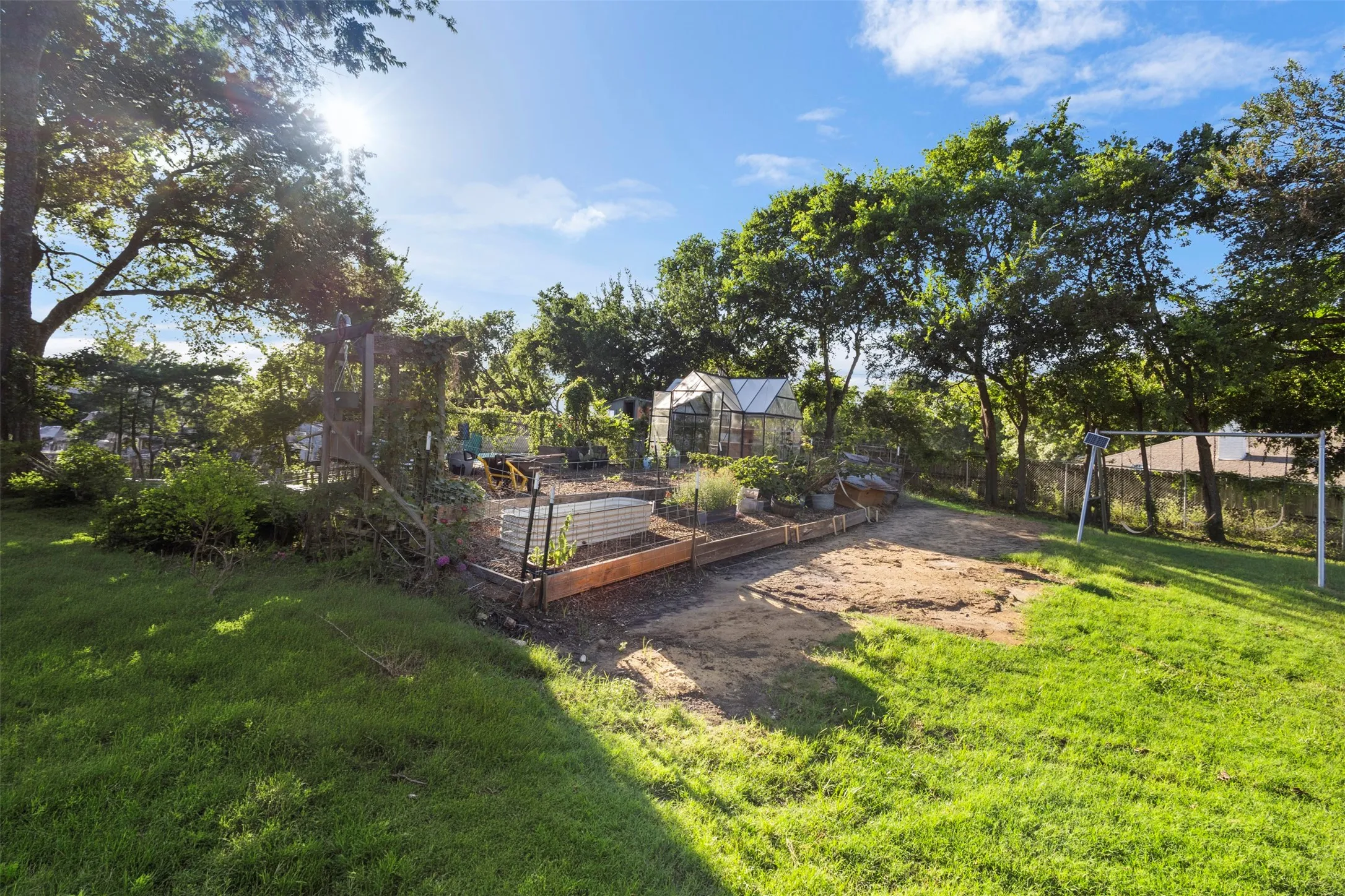The backyard is already set up with a garden and chicken coop!
