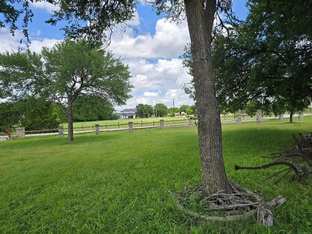 Mansion under construction can be seen from the front yard looking northward across Creek Bend Lane