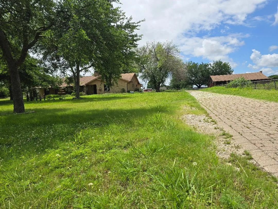 View of the home on the left and pavilian on the right from just inside the front gate