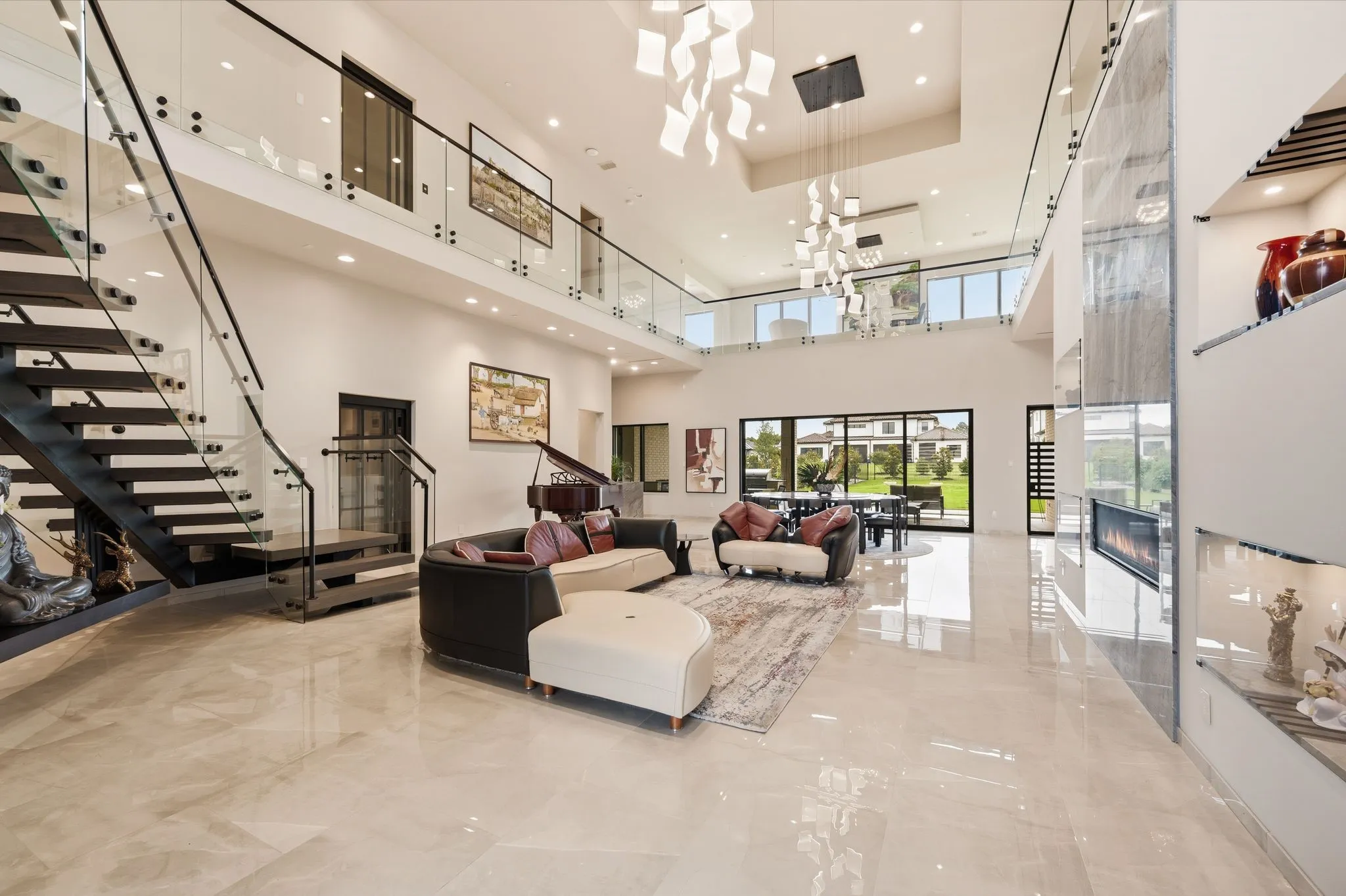 Grand entry showcasing soaring ceilings, floating staircase, and open-concept design.