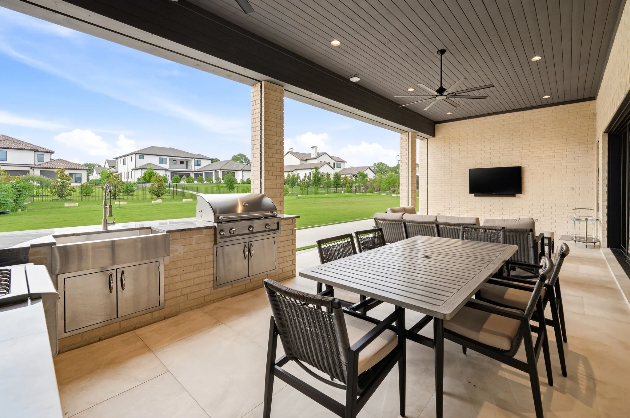 Covered outdoor kitchen and dining area designed for year-round entertaining.