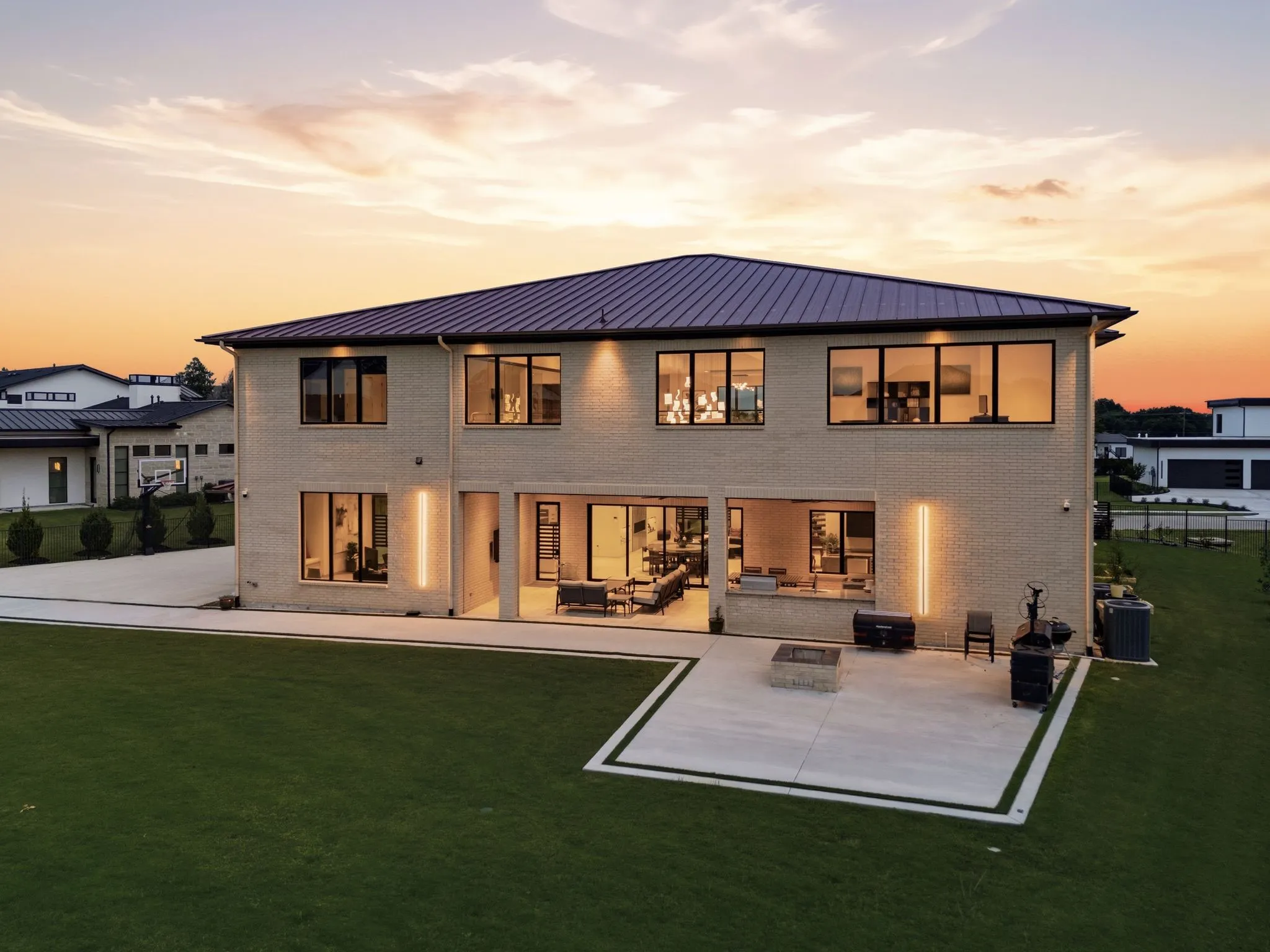 Architecturally striking rear elevation overlooking private outdoor living spaces.