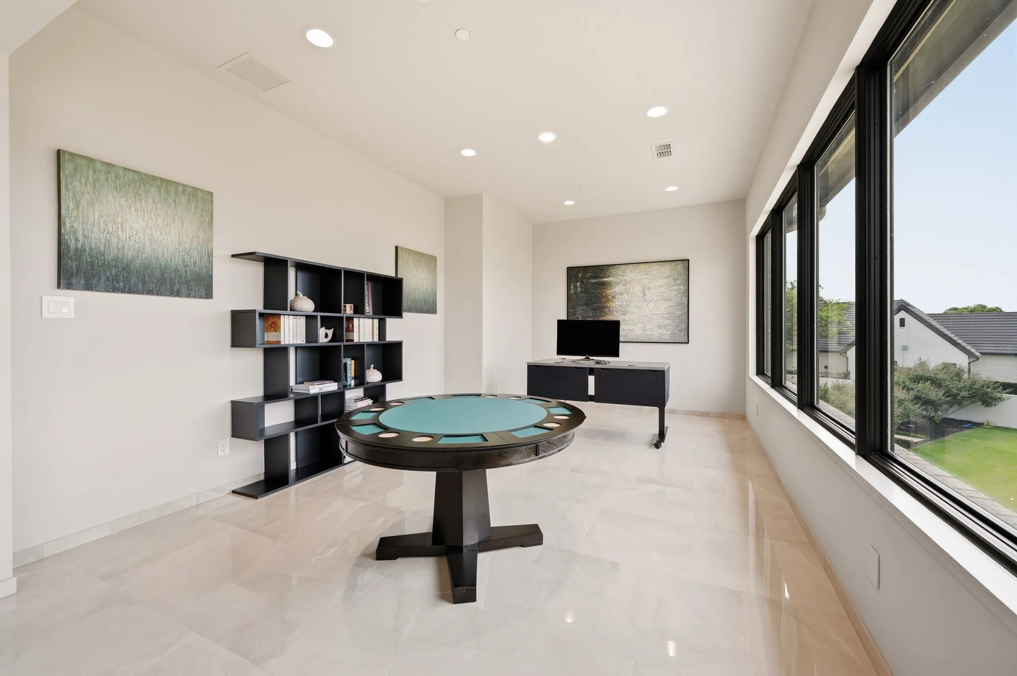 Expansive game room with abundant natural light and entertaining potential.