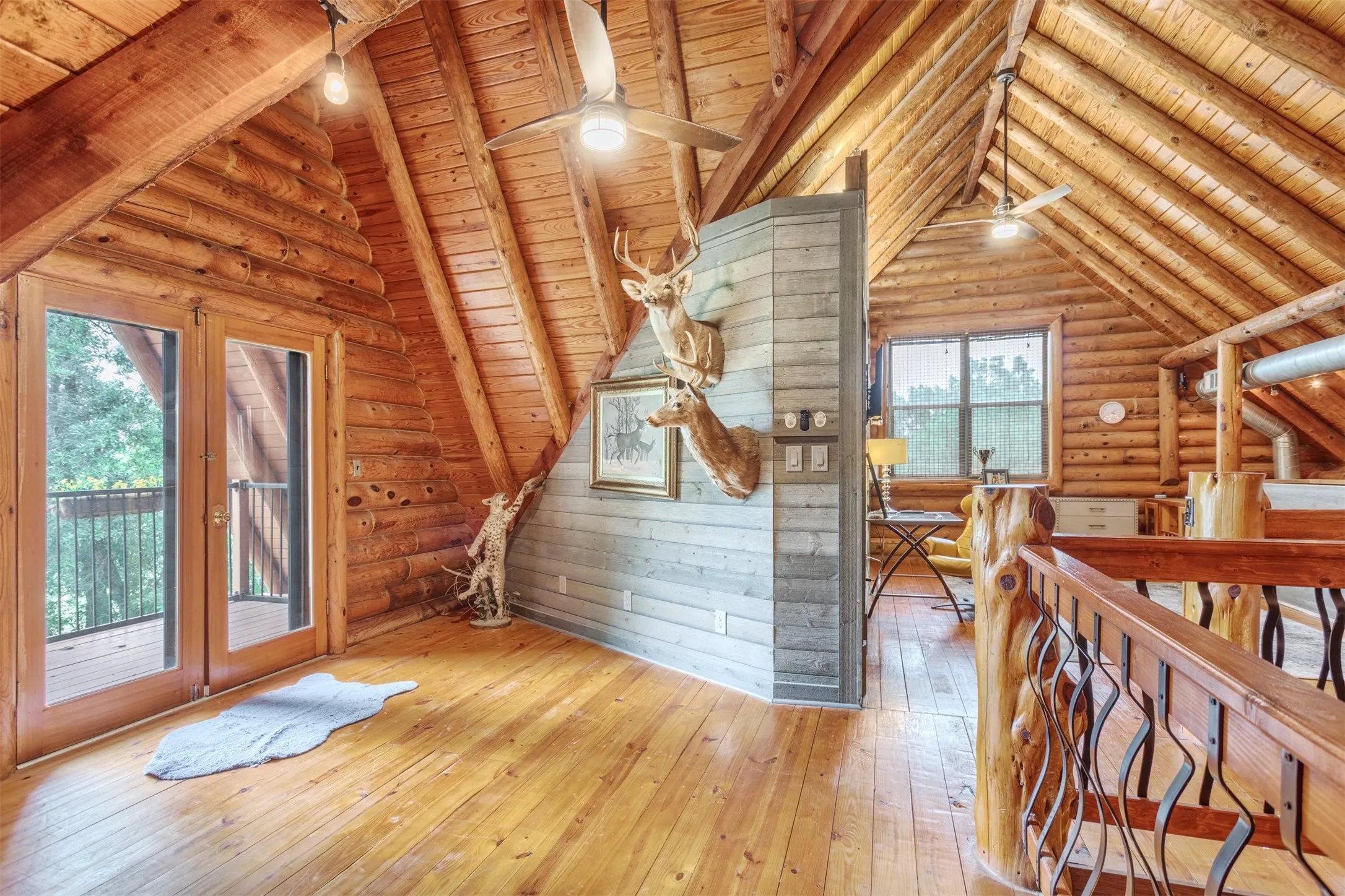 Balcony off the loft area overlooking the front of the property, full bath, living space, closet, storage and sleeping area.