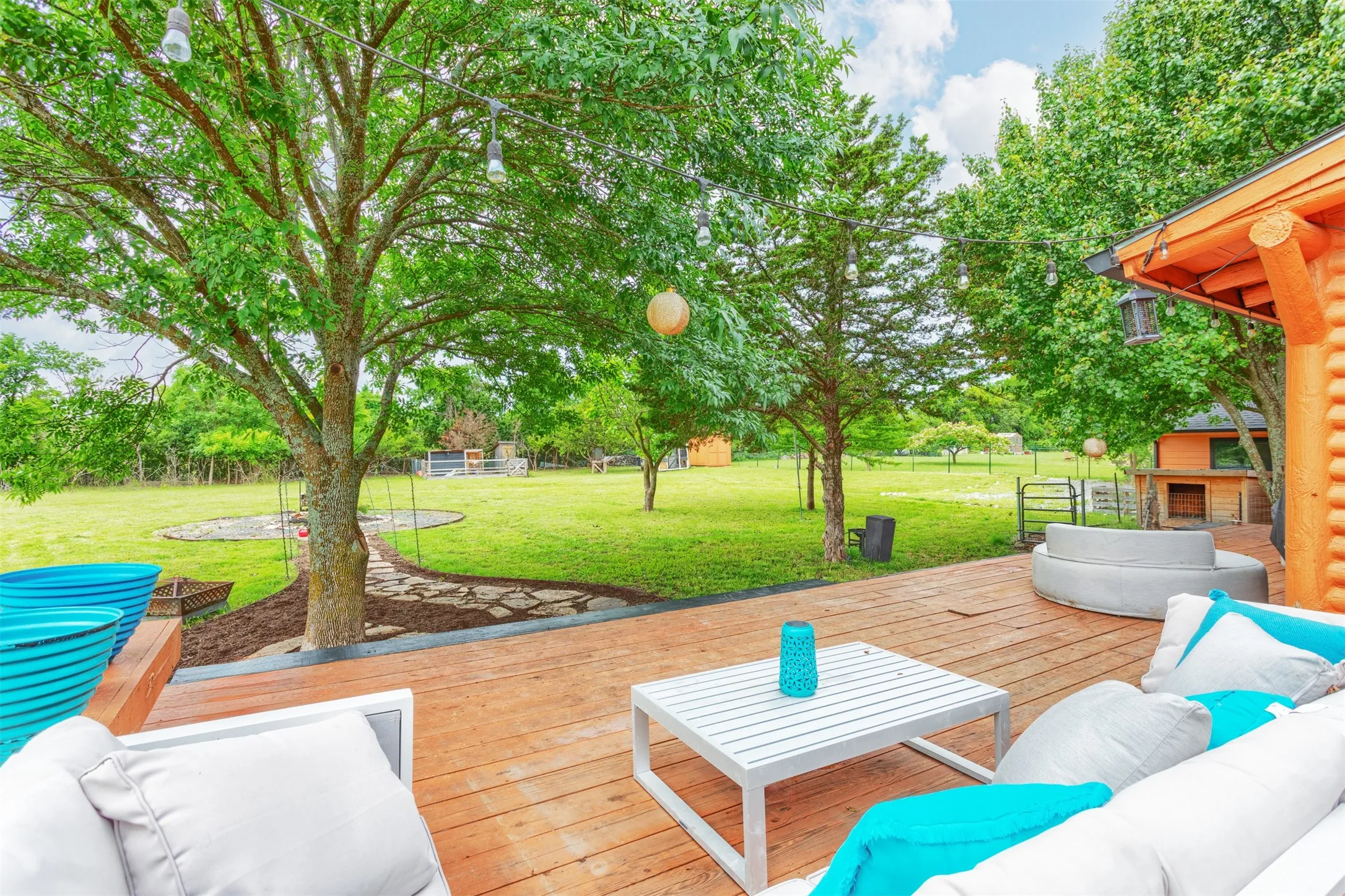 Huge backyard deck across the back of the original log cabin, perfect for entertaining!