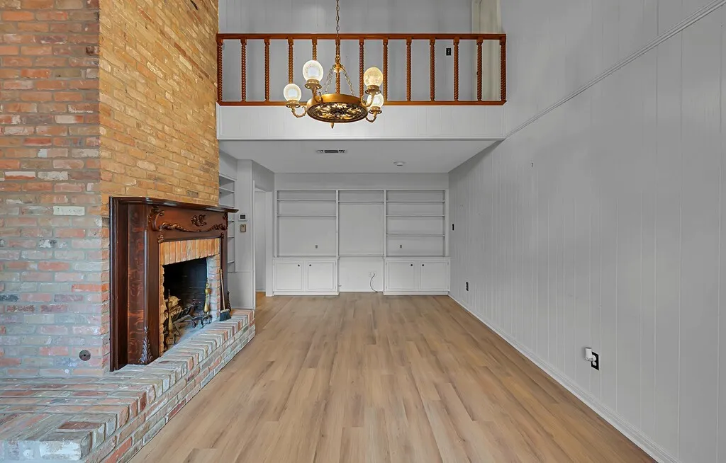 Features wall of Shelving and space for TV.