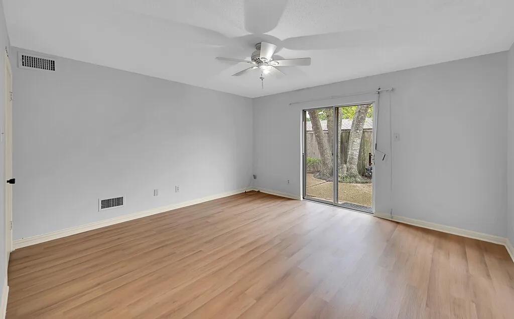 Downstairs Primary Bedroom with Sliding Glass Door to Back Patio.