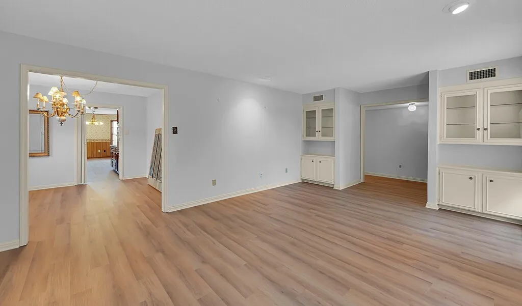 Front Living Room Featuring Built-in Cabinets, Custom Lighting & Fresh Luxury Vinyl Plank
