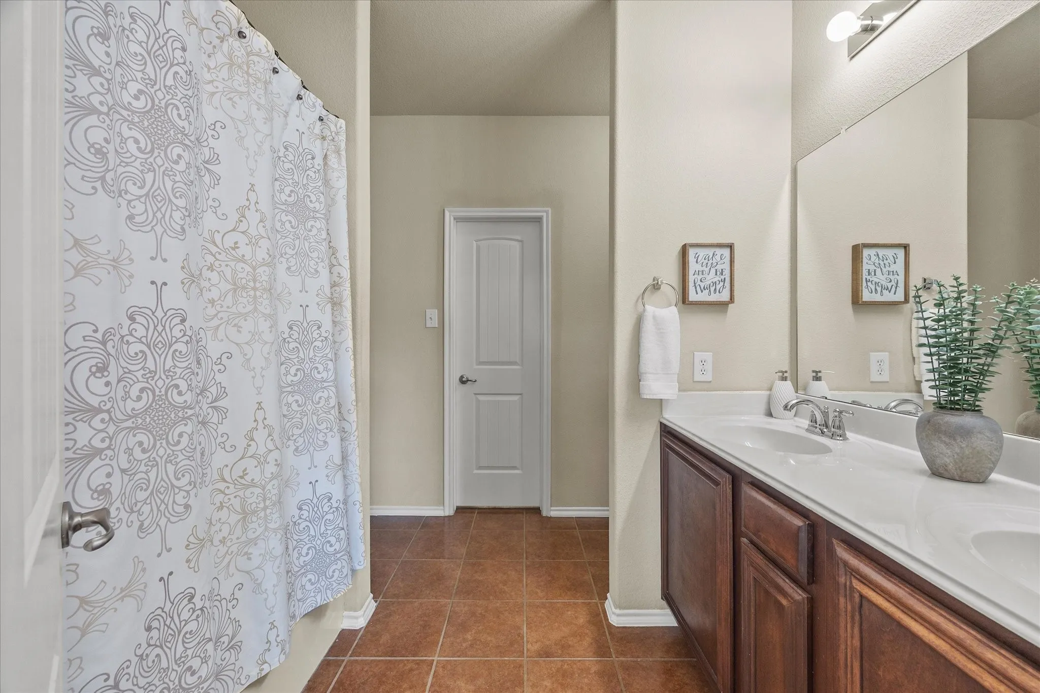 Bathroom featuring a double vanity with white countertops, undermount sinks, and chrome faucets