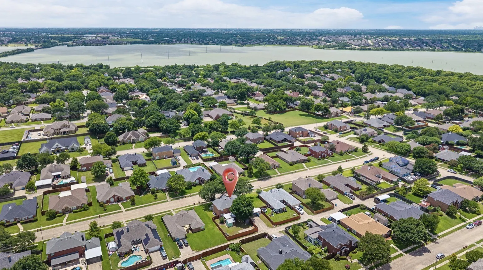 Aerial perspective showcasing a residential neighborhood with established homes and mature trees