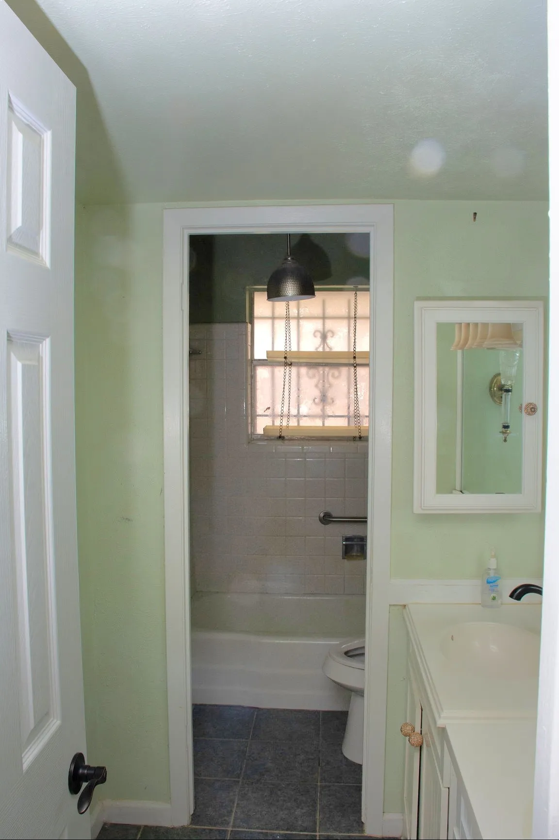 Bathroom entry featuring a vanity with an integrated sink and mirror