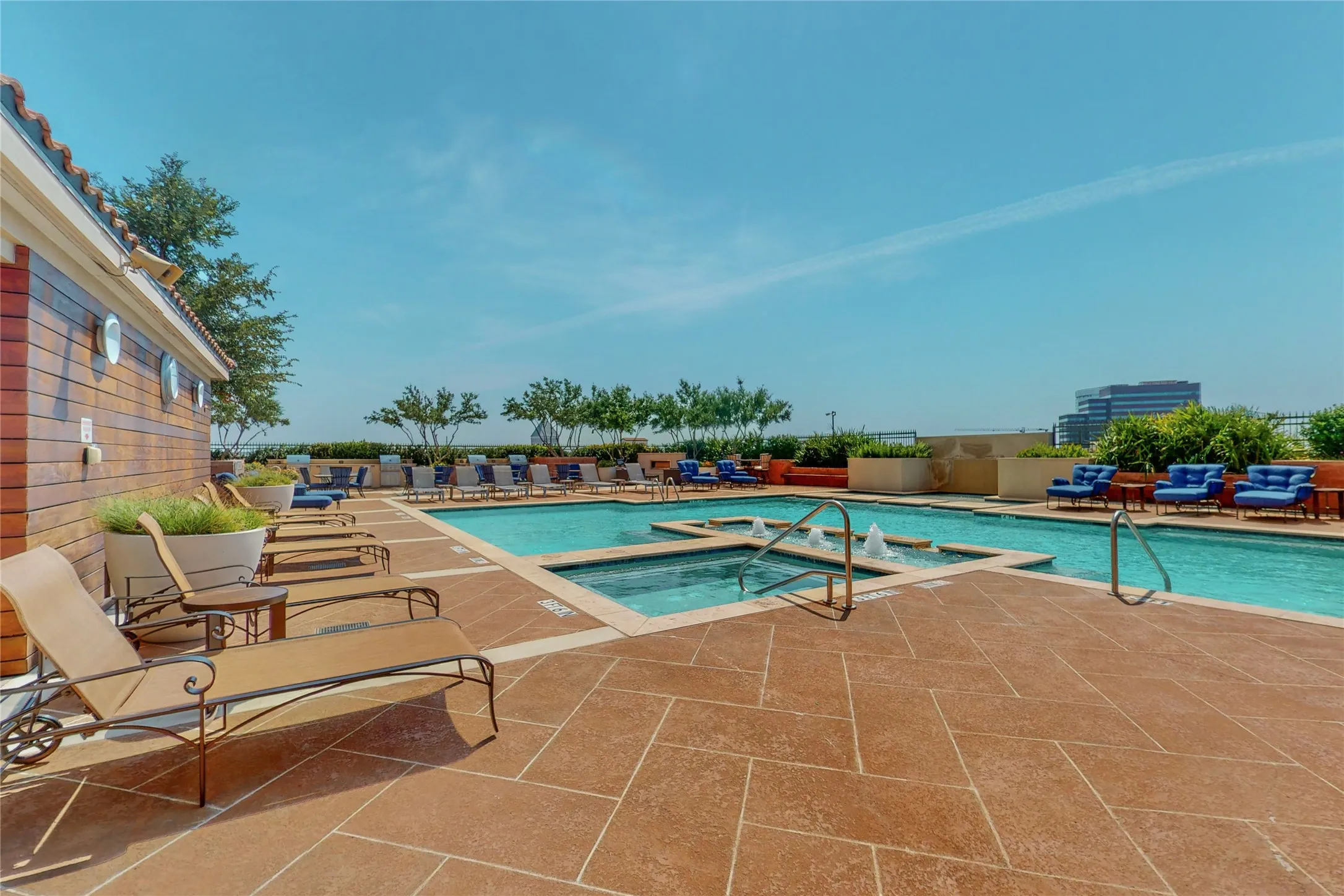 View of pool featuring a community hot tub and a patio area