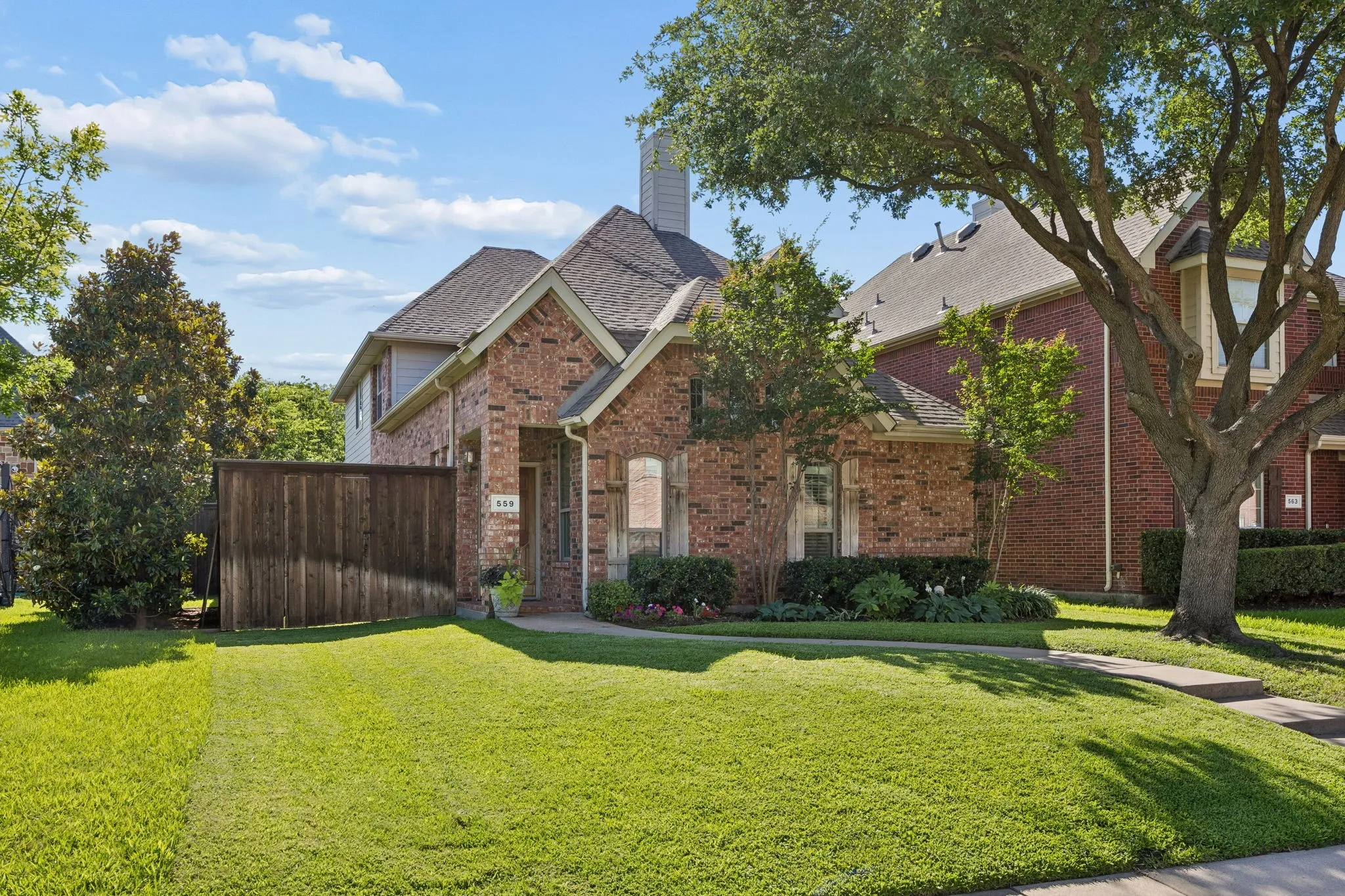 Brick exterior with stone accents, a gabled roofline, and a prominent chimney