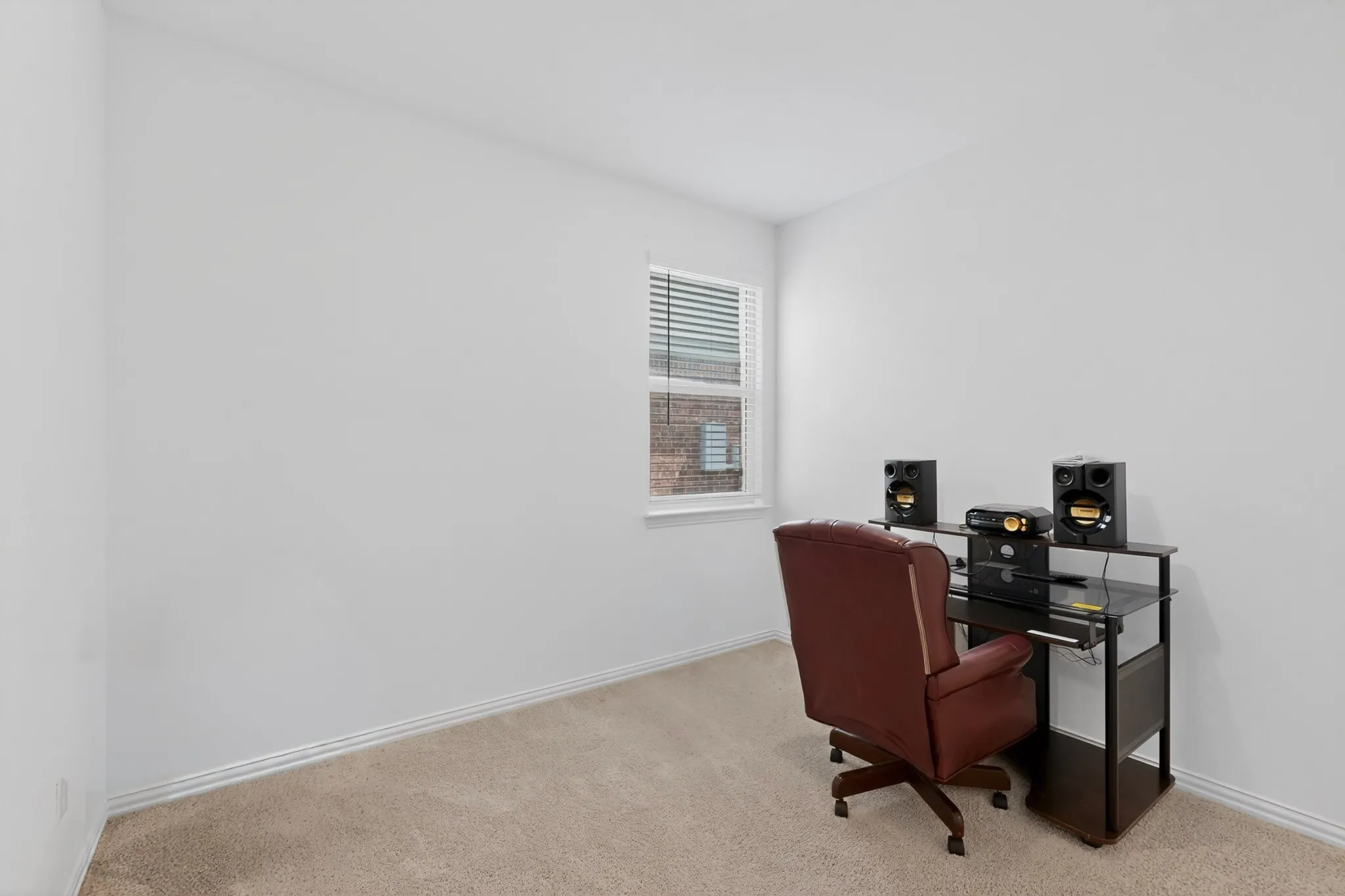 Carpeted room featuring light-colored walls and baseboards