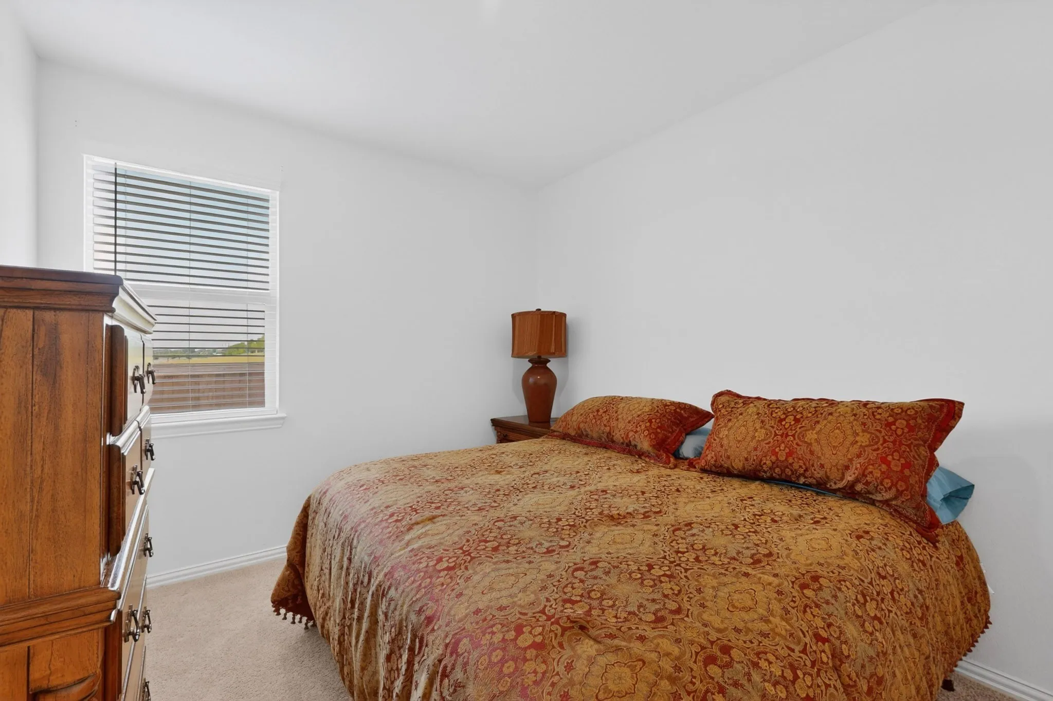 Room featuring neutral wall paint, white trim, and light-toned carpet flooring