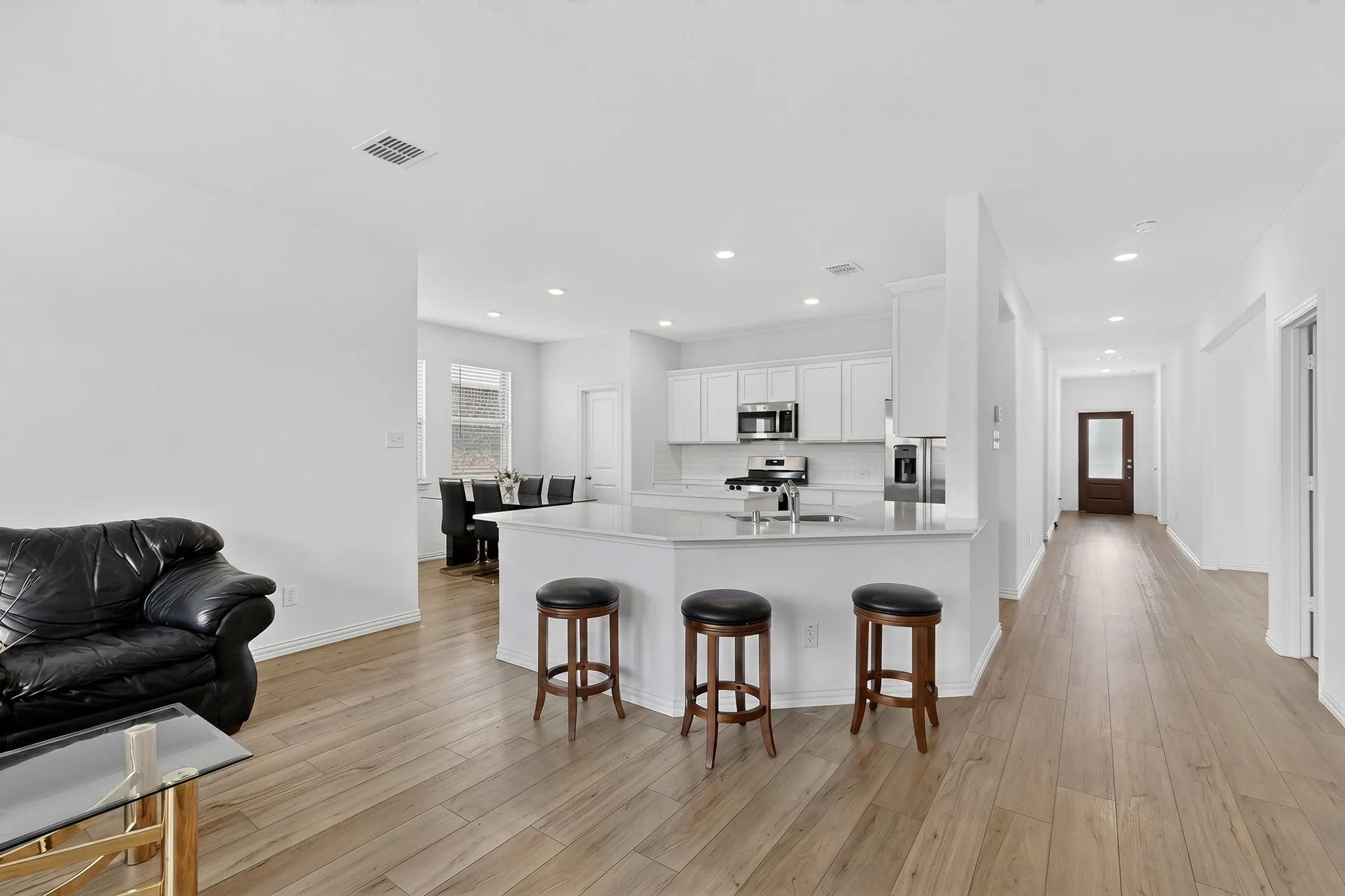 Kitchen island with a light-toned countertop and integrated sink
