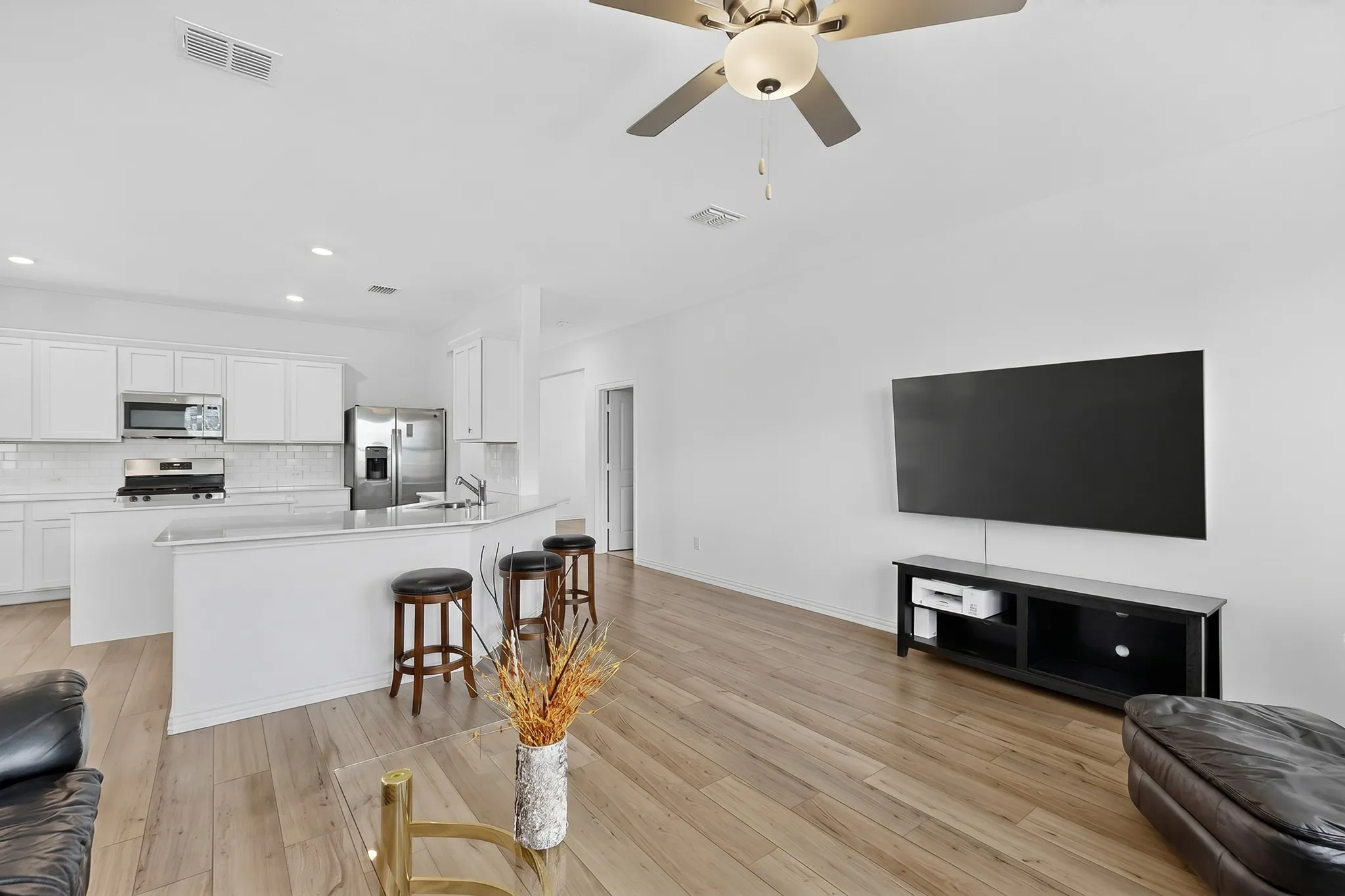 Open-concept living space featuring wood-finish flooring throughout