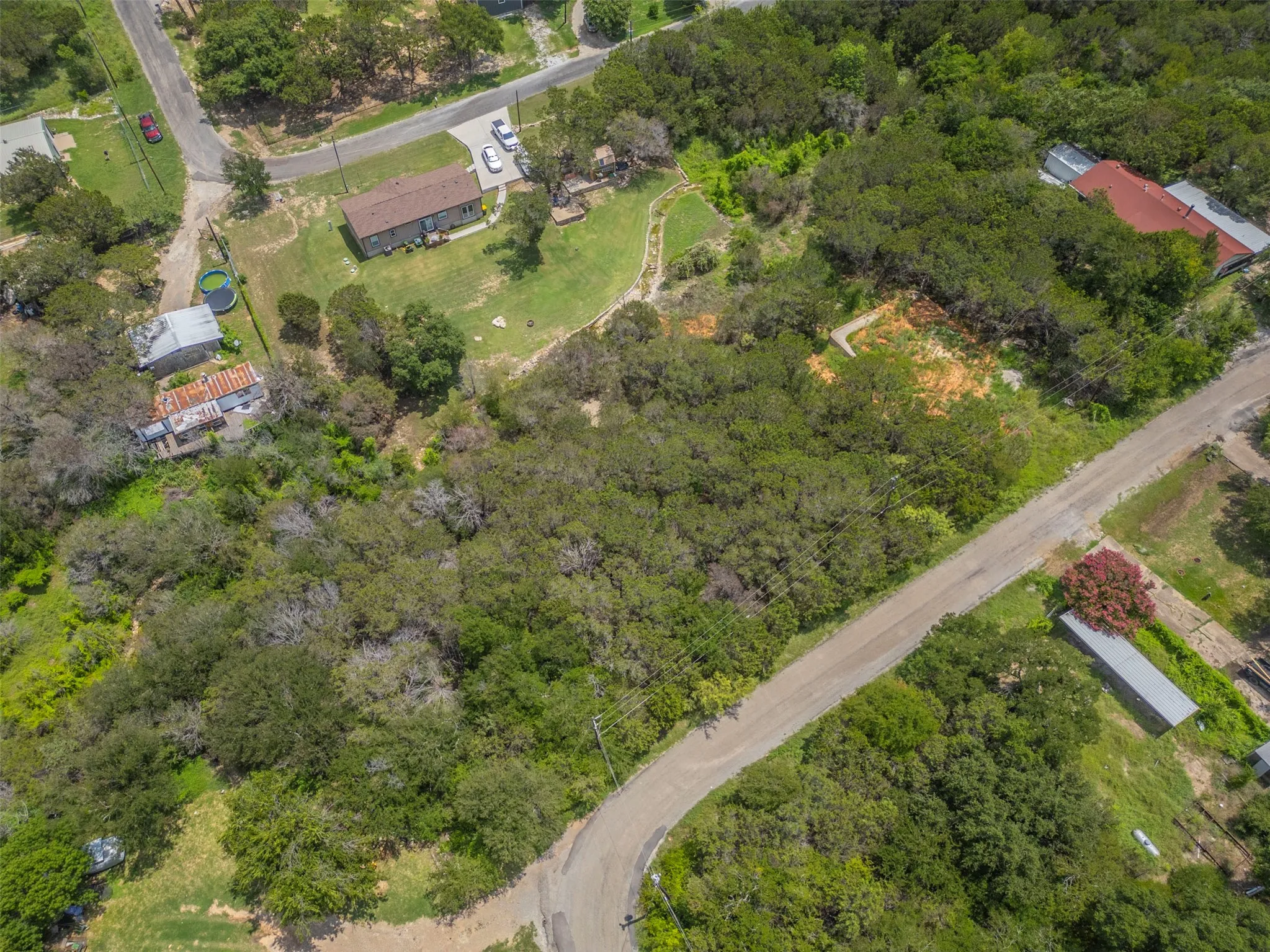 Expansive undeveloped land parcel featuring mature tree coverage and natural foliage
