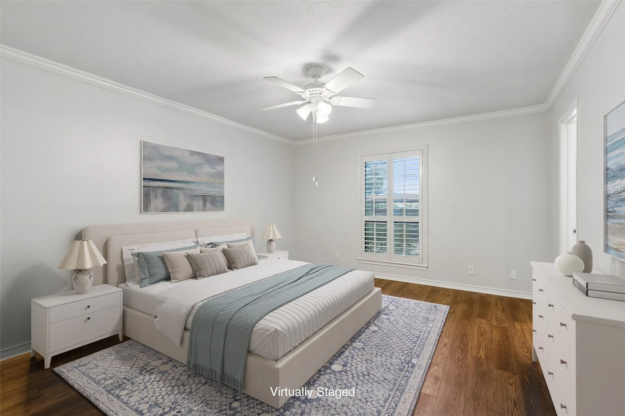 Primary bedroom offers plantation shutters, ample natural light, and generous closet space.