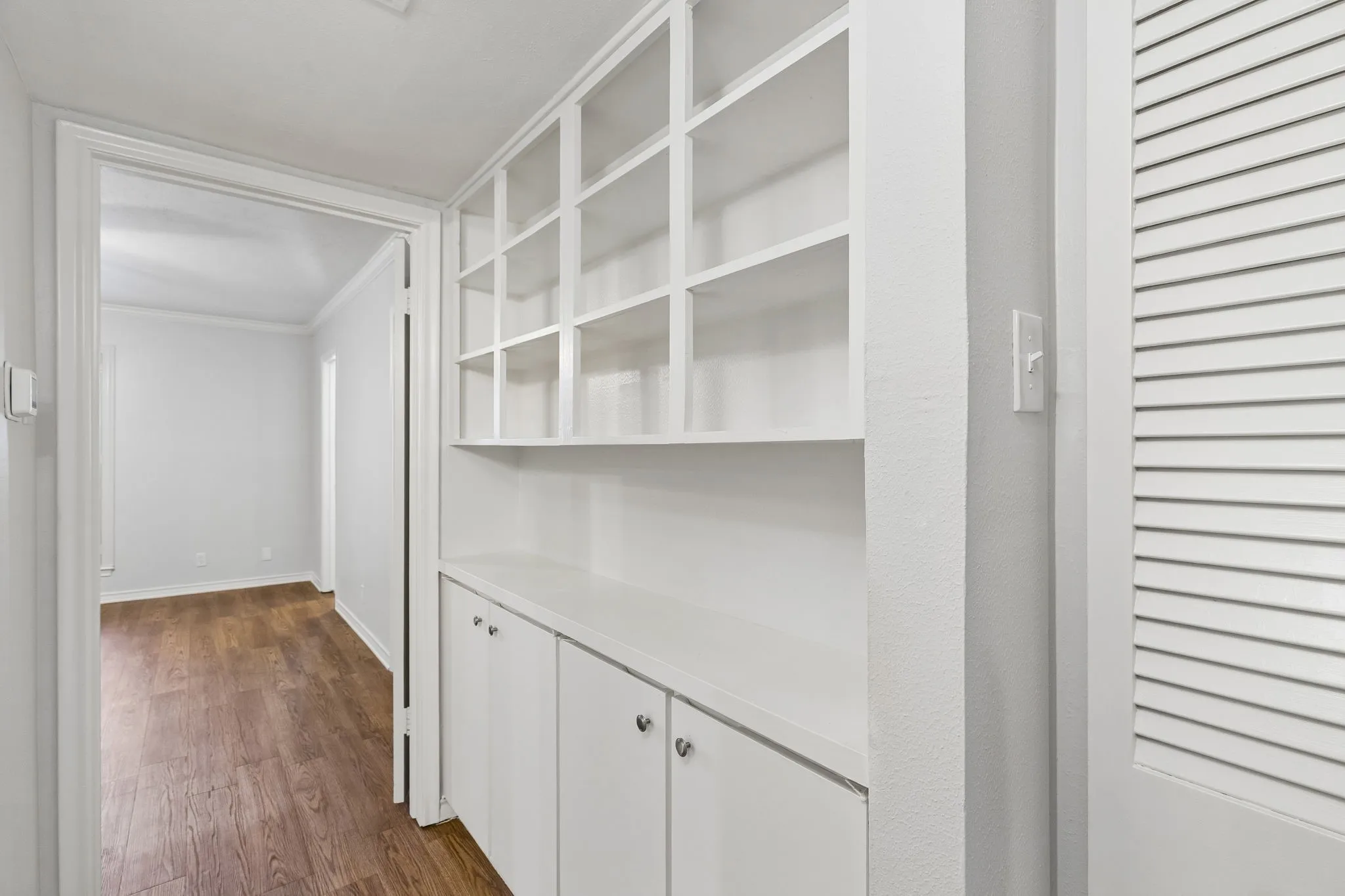 Custom built-in shelving and cabinetry in the hallway add valuable extra storage.