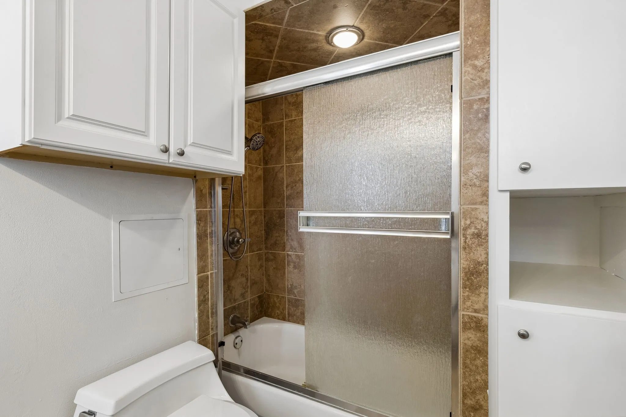 Primary bathroom features a shower and tub combination with granite countertops.