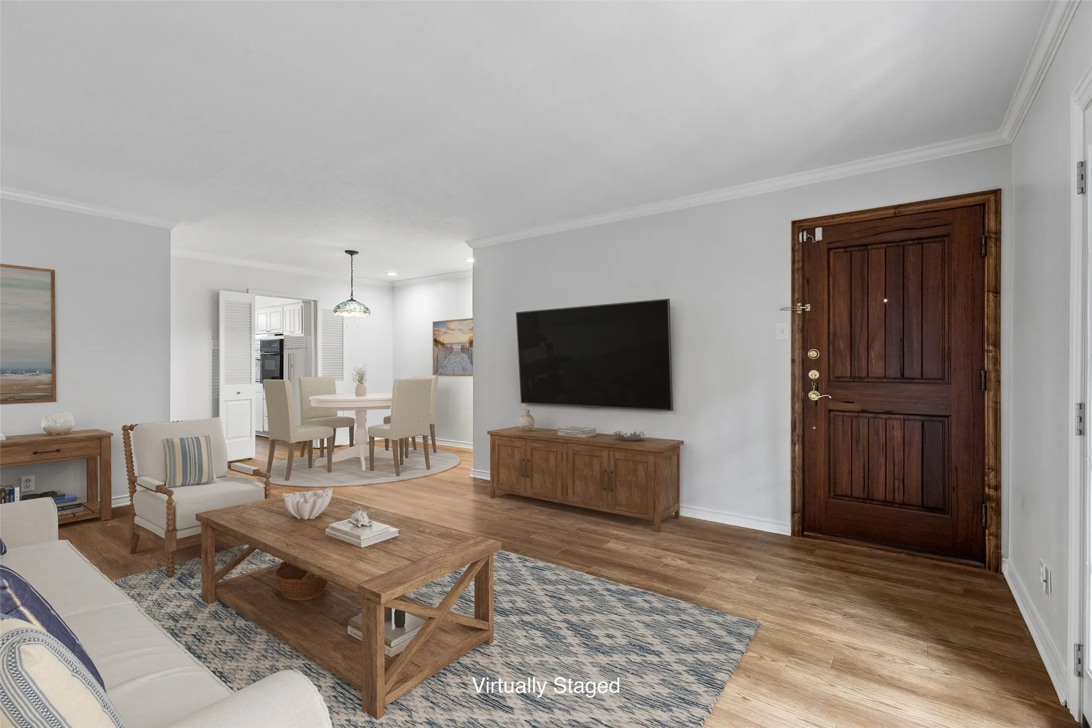 Open concept design connects the living and dining areas, with the kitchen just beyond.