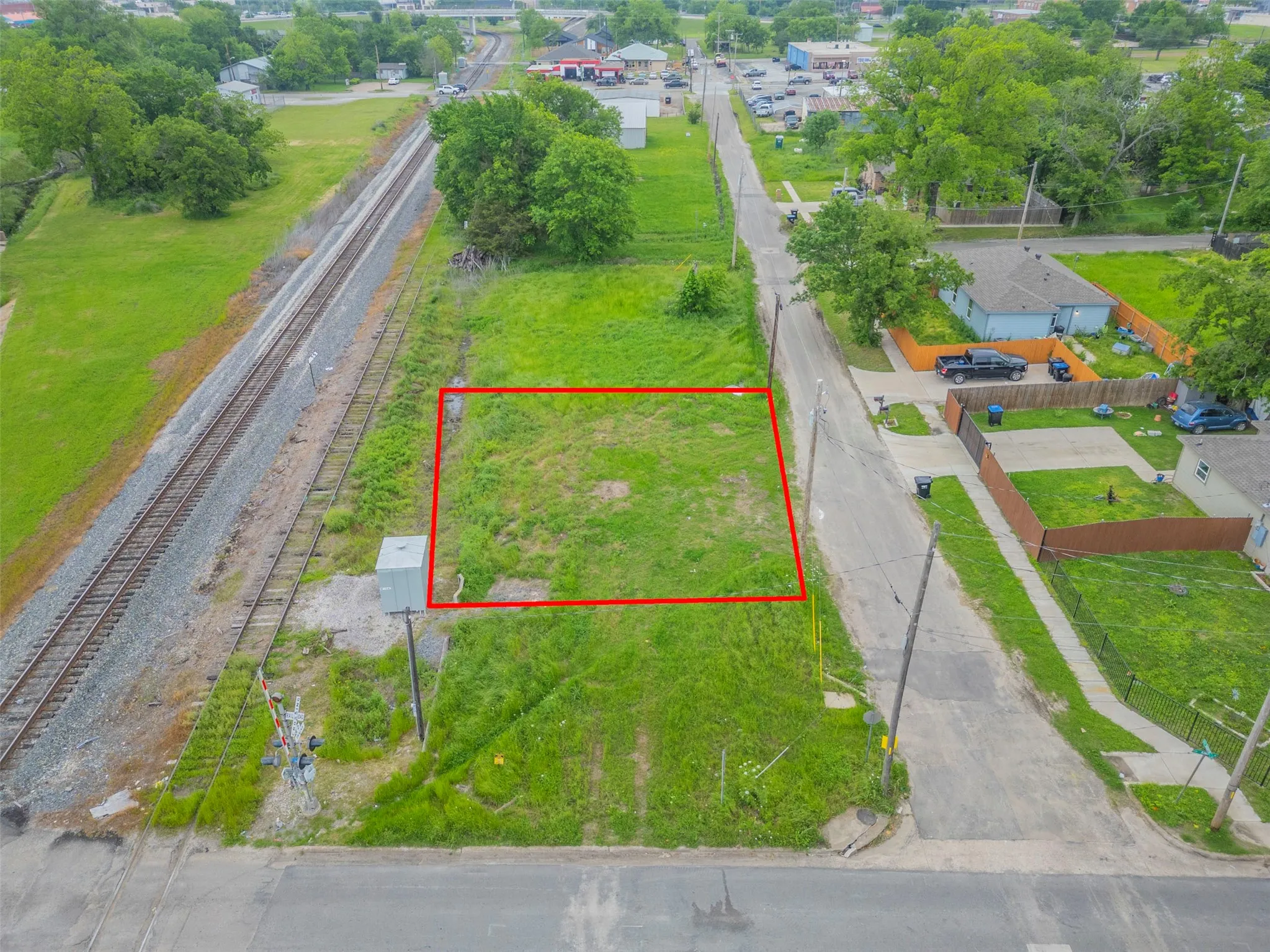 Level lot with established street access, featuring a clear, grassy expanse