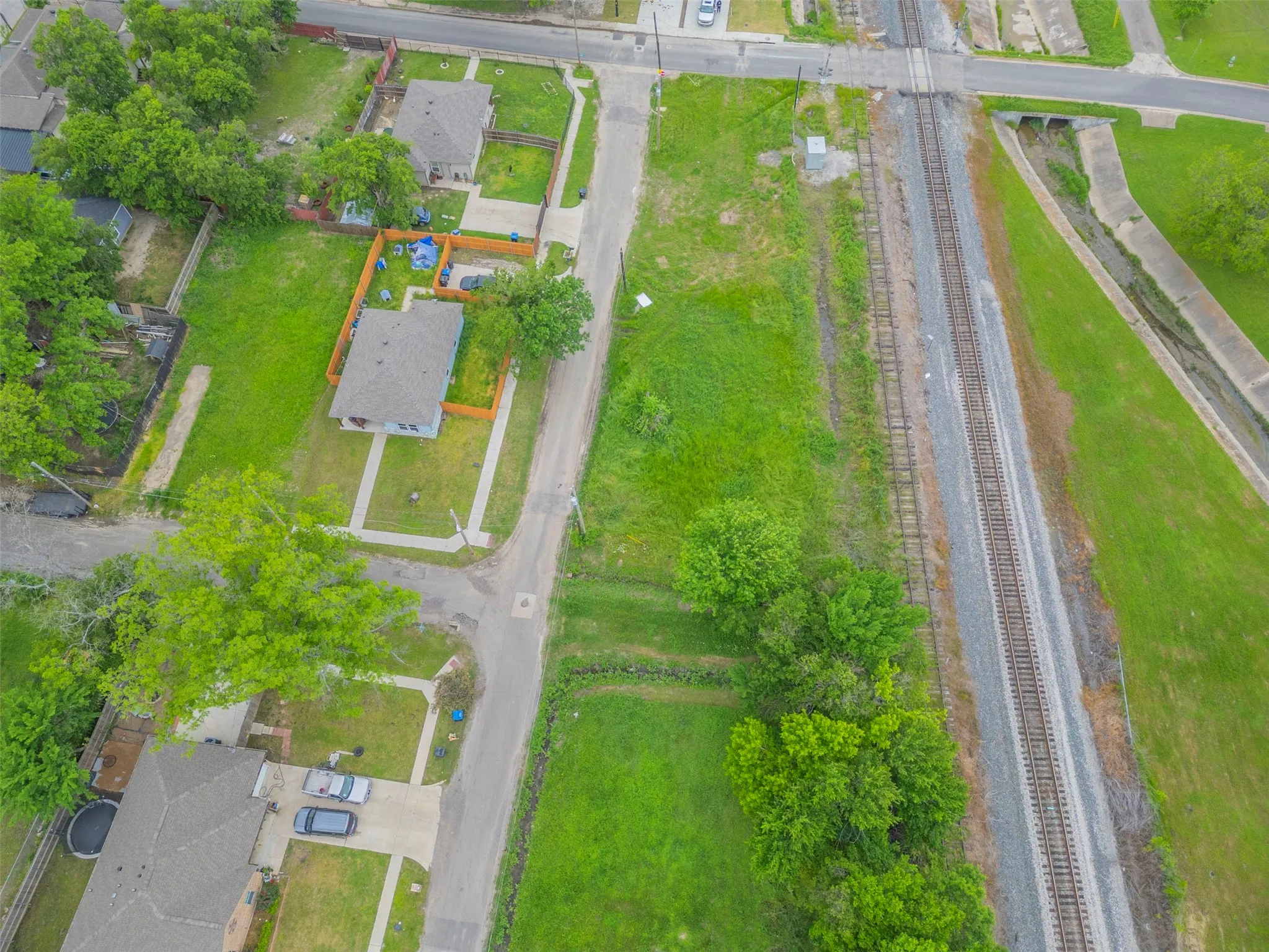 Aerial perspective showcasing a residential property with a gray shingle roof and an attached concrete driveway