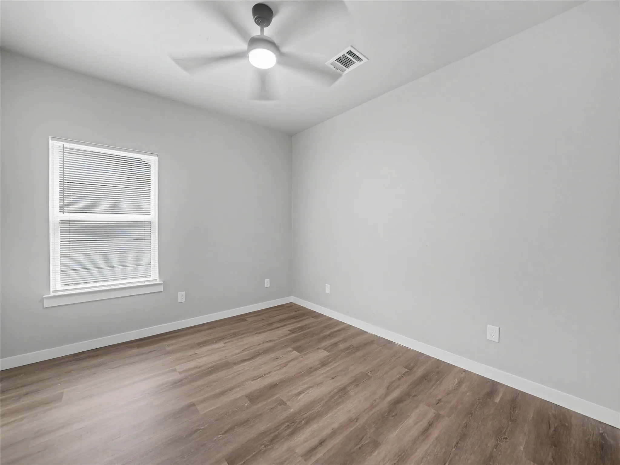 Neutral tone walls paired with wood-finish flooring