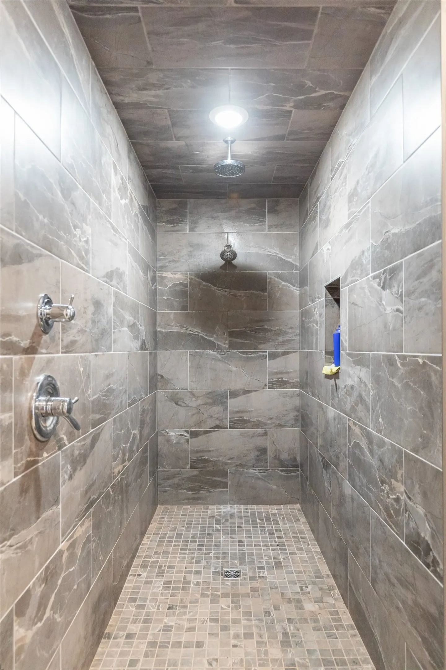 Walk-in shower with large format tile walls and ceiling