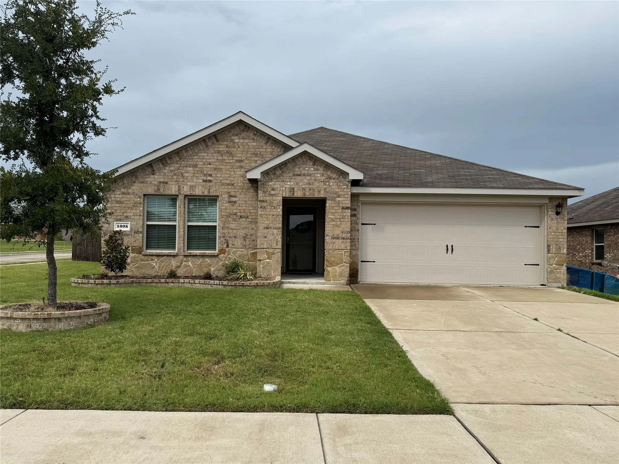 Brick and stone exterior with a two-car garage