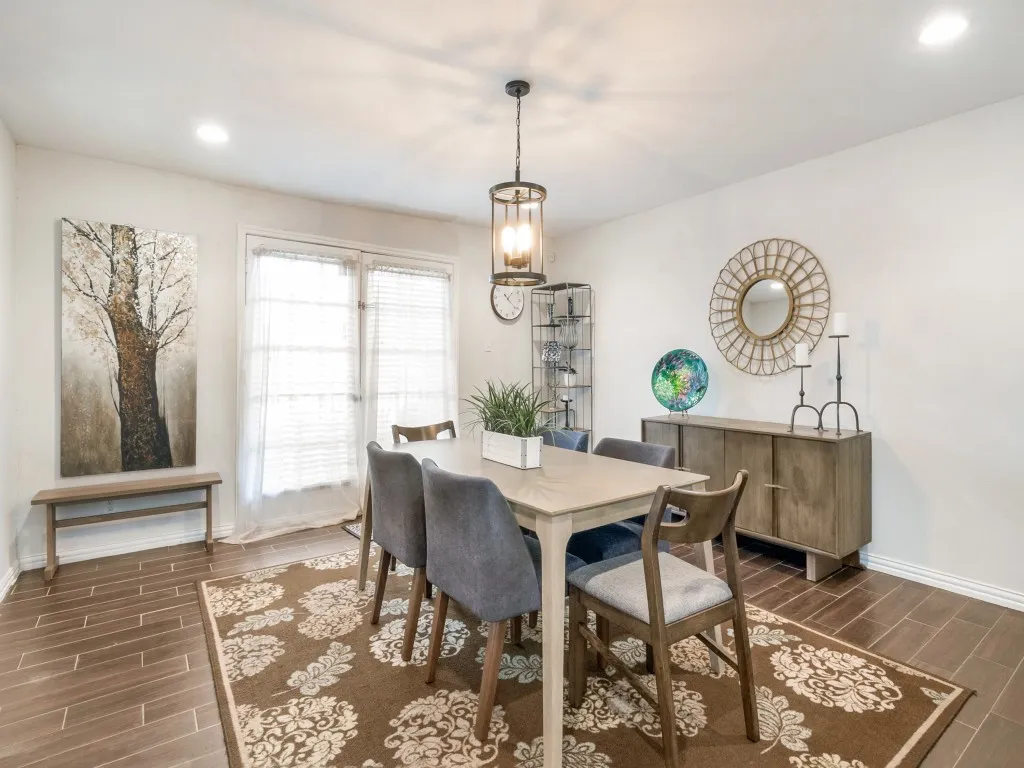 Spacious dining area perfect for entertaining or family gatherings, featuring direct French door access to the front patio.