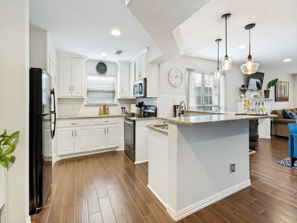 Gorgeous kitchen with granite counters, built-in cabinets, and a huge walk-in pantry.