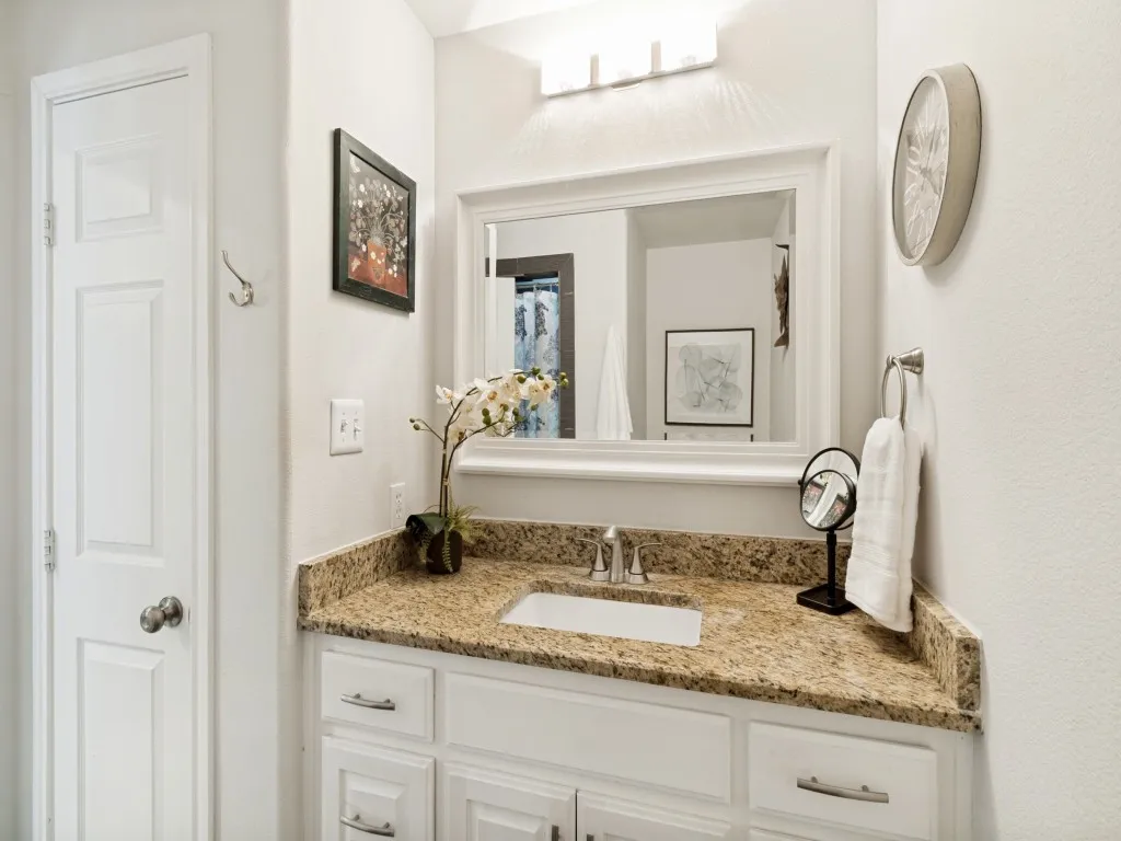 Spacious tiled walk-in shower, granite vanity and built-in pantry for extra storage.