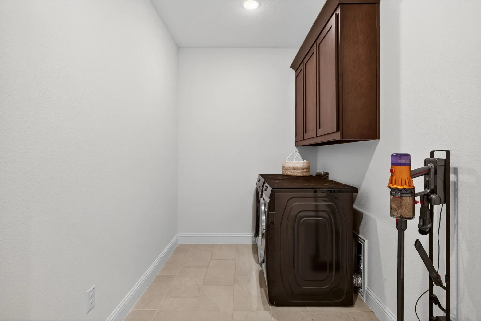Laundry room with upper cabinetry and (not pictured) a great mud area with hooks and a bench.