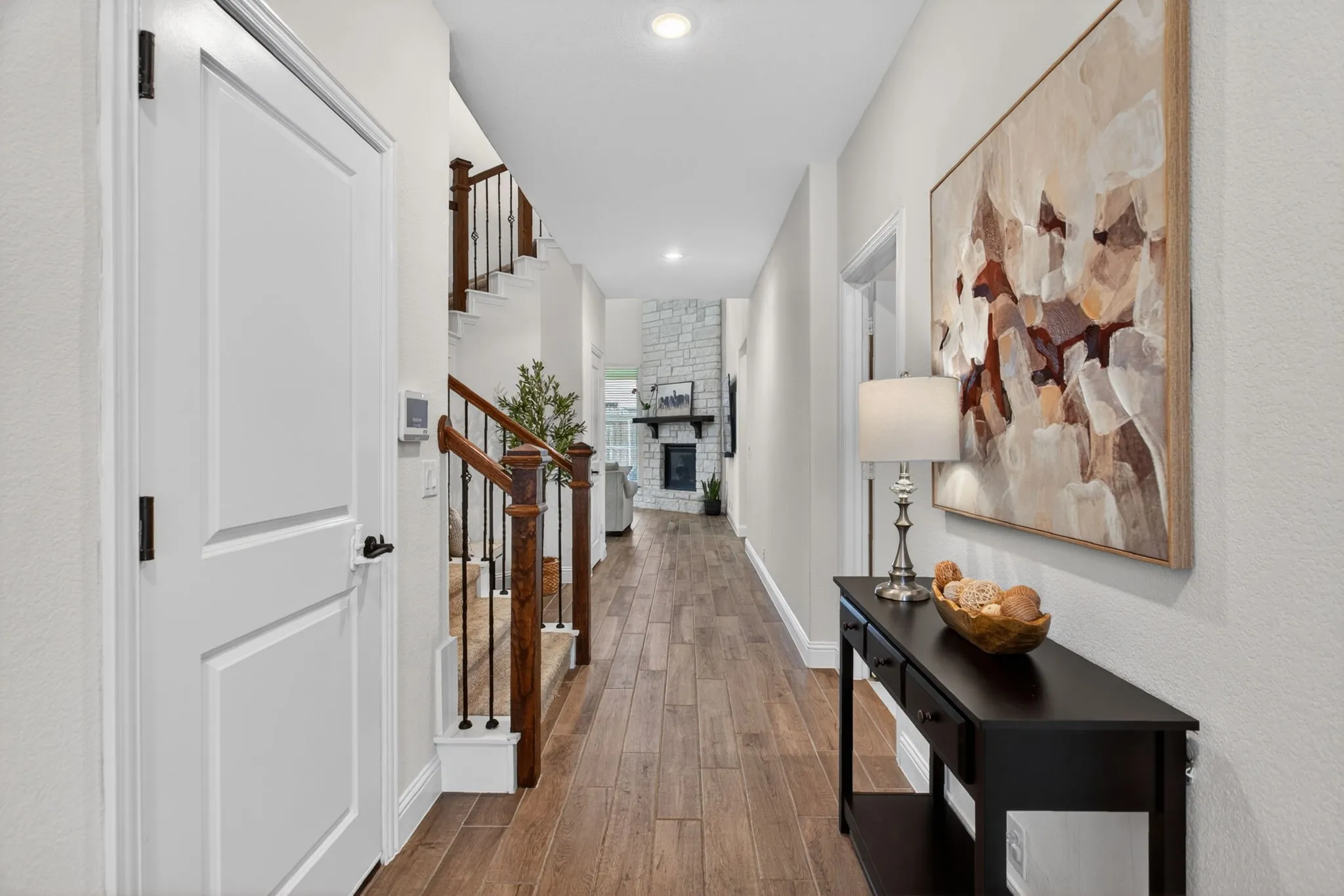 Walk past the downstairs guest suit and the laundry room into the two-story living room.