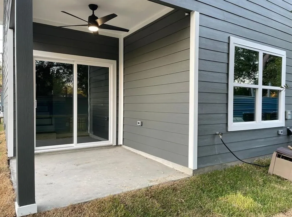 A private concrete patio extends from the home, offering seamless indoor-outdoor living.
