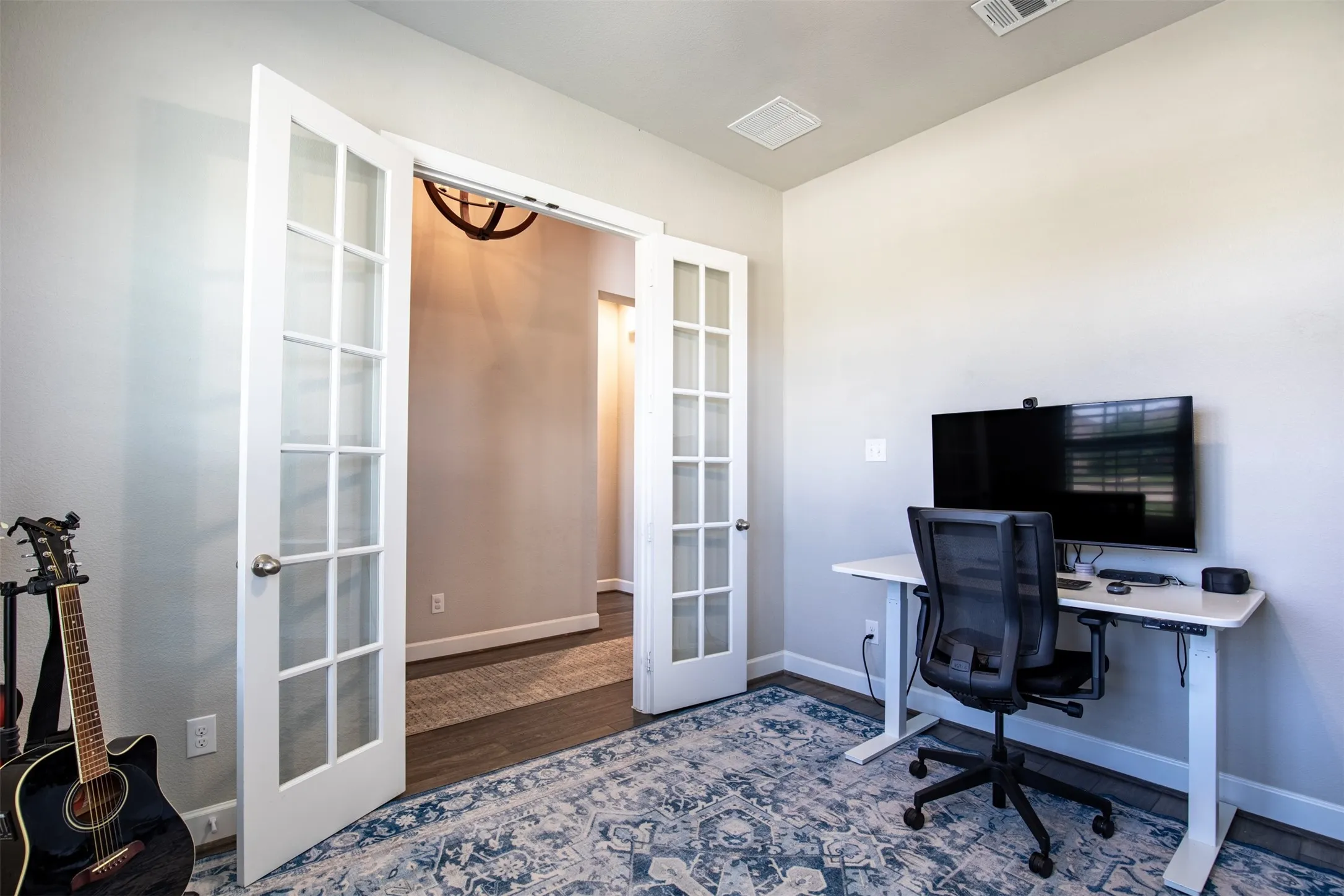 Private office with french doors and durable flooring.