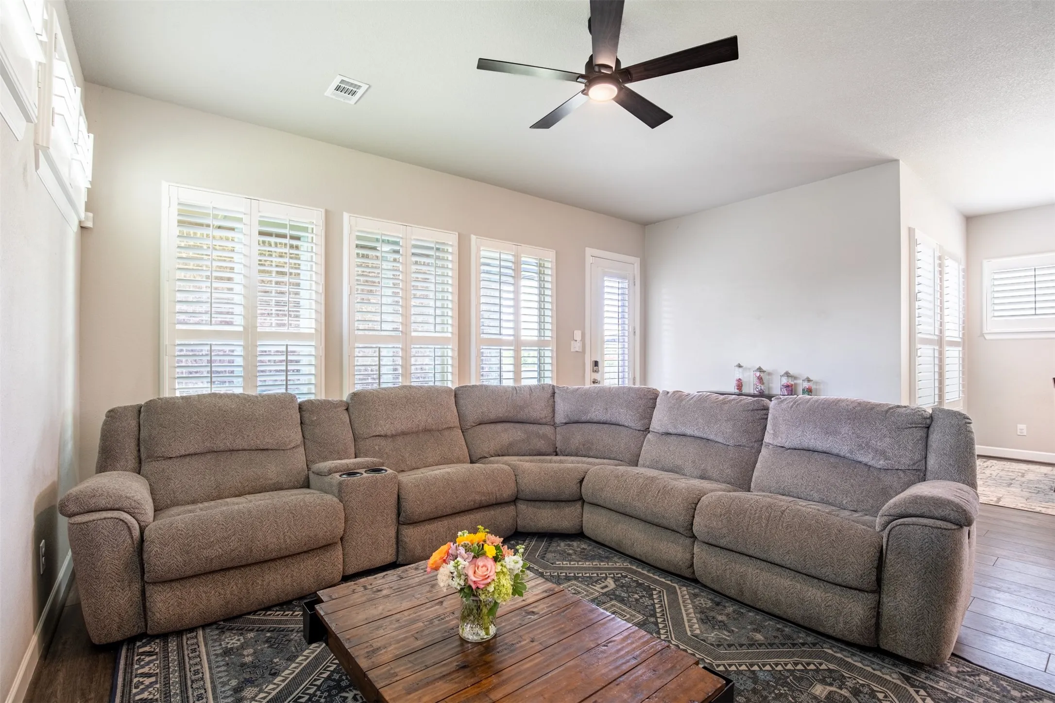Beautifully appointed room with custom plantation shutters offering abundant natural light and an airy, inviting atmosphere.